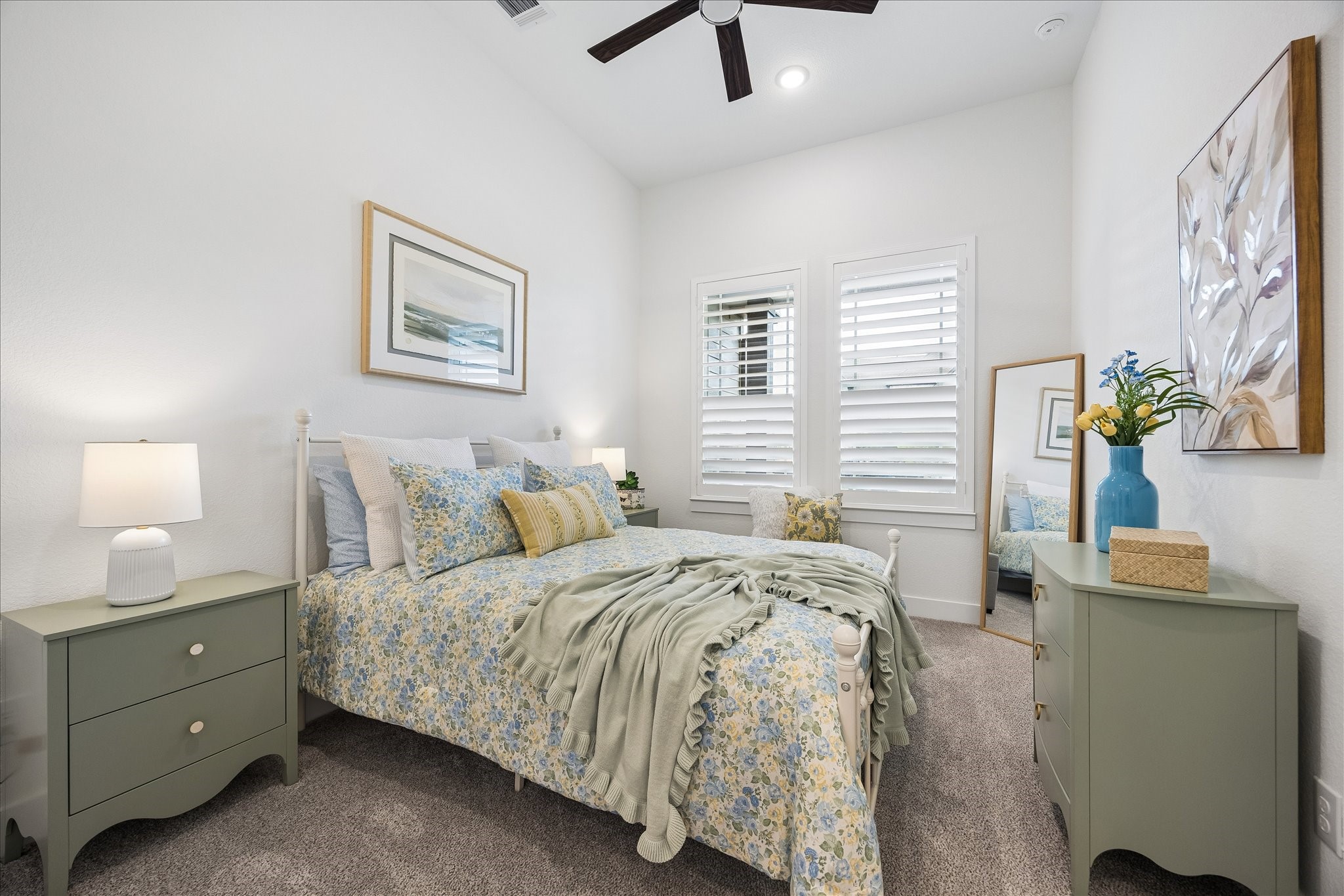 One of the three secondary bedrooms featuring custom plantation shutter, upgraded carpet and ceiling fan.