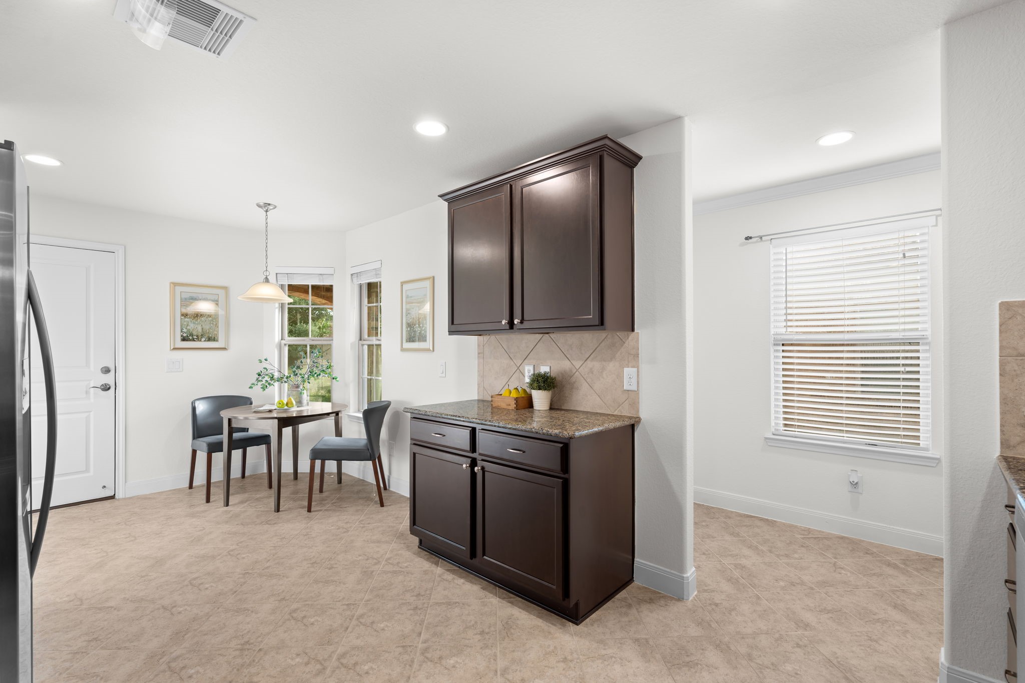 Warm cabinetry creates an inviting atmosphere in this practical kitchen!
