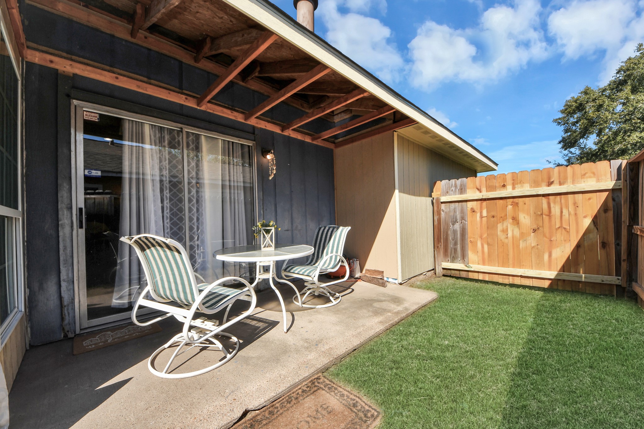 Enjoy your morning coffee or unwind after a long day on the inviting side patio, conveniently located just off the living room. A perfect spot to relax