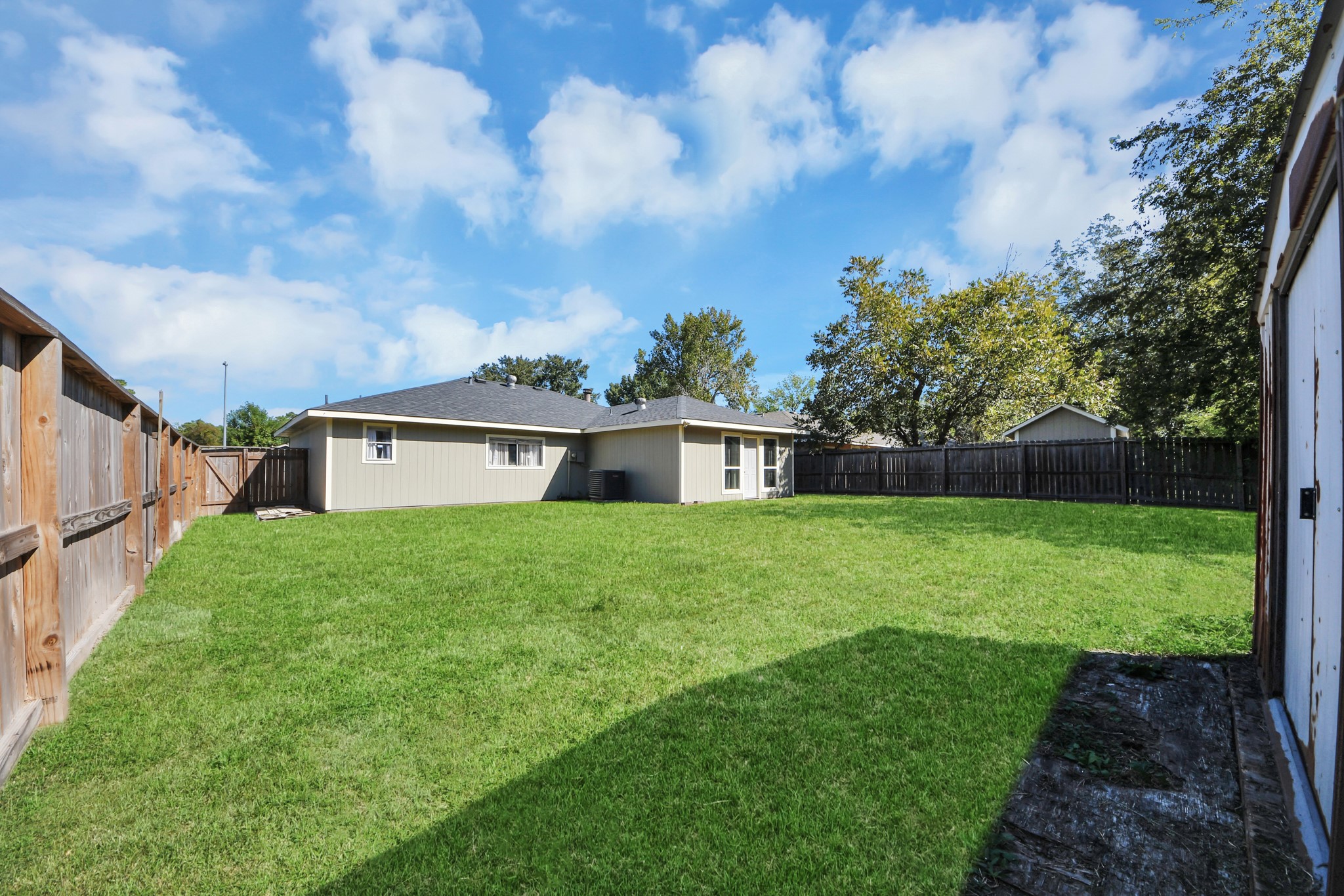 Spacious backyard with endless possibilities! Plenty of room for outdoor activities, family gatherings, or entertaining. Create your dream outdoor retreat by adding a covered patio, outdoor kitchen, or expanding the existing outdoor living space.