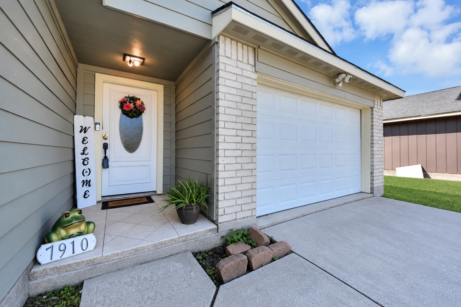 Charming covered front porch featuring updated exterior siding, a decorative glass entry door, and welcoming accents. A beautiful first impression that invites you into this lovely home! Charming covered front porch featuring updated exterior siding, a decorative glass entry door, and welcoming accents. A beautiful first impression that invites you into this lovely home!