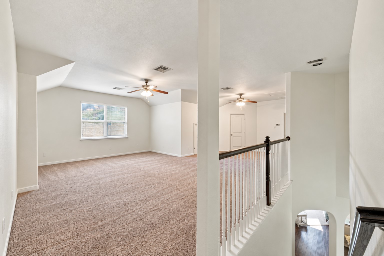 This photo has been digitally (un)staged (all furniture and decor removed) to show the potential of this expansive Game Room upstairs. | Curious how your furniture would look? Download this picture and take pictures of your current furniture and upload both into ChatGPT and ask it to stage the room using your furniture--it won't look exact but it can give you a great idea!