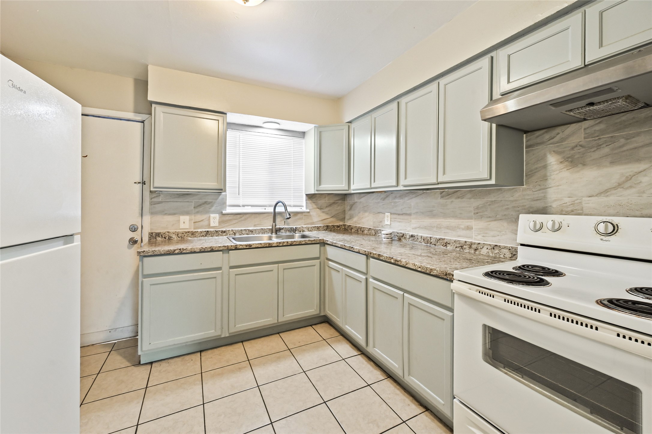 Updated Kitchen with Refrigerator, Stove and Vent Hood