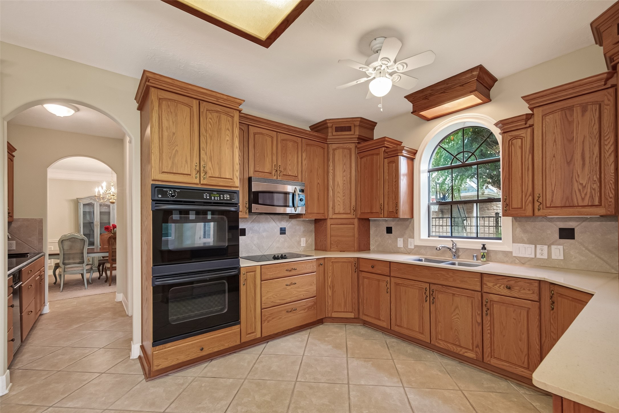 This view shows the Butler's Pantry to the right and leads to the Formal Dining Room. Custom cabinets and double ovens in the Kitchen.