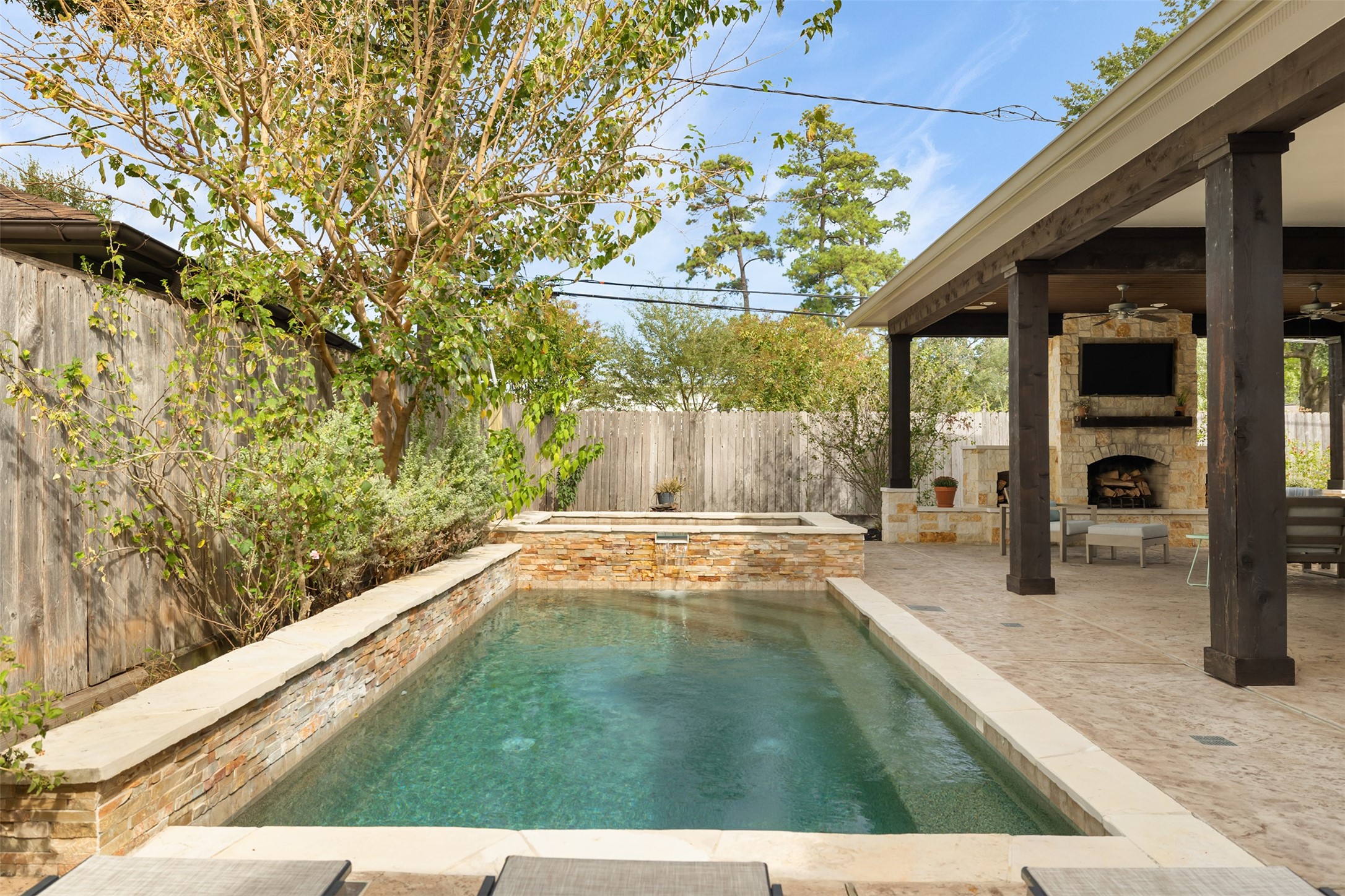 The pool is next to the outdoor living