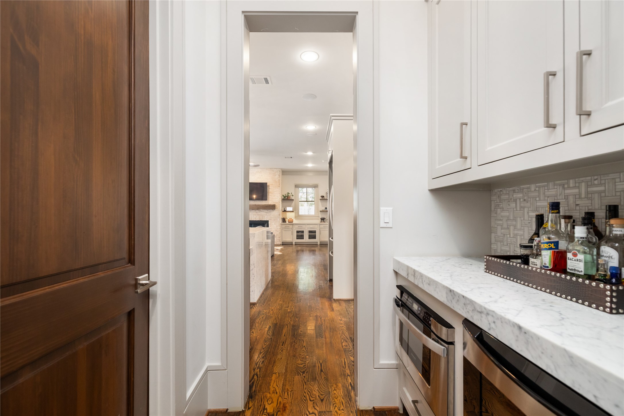 The butlers pantry is just off the kitchen and across from the walk-in pantry