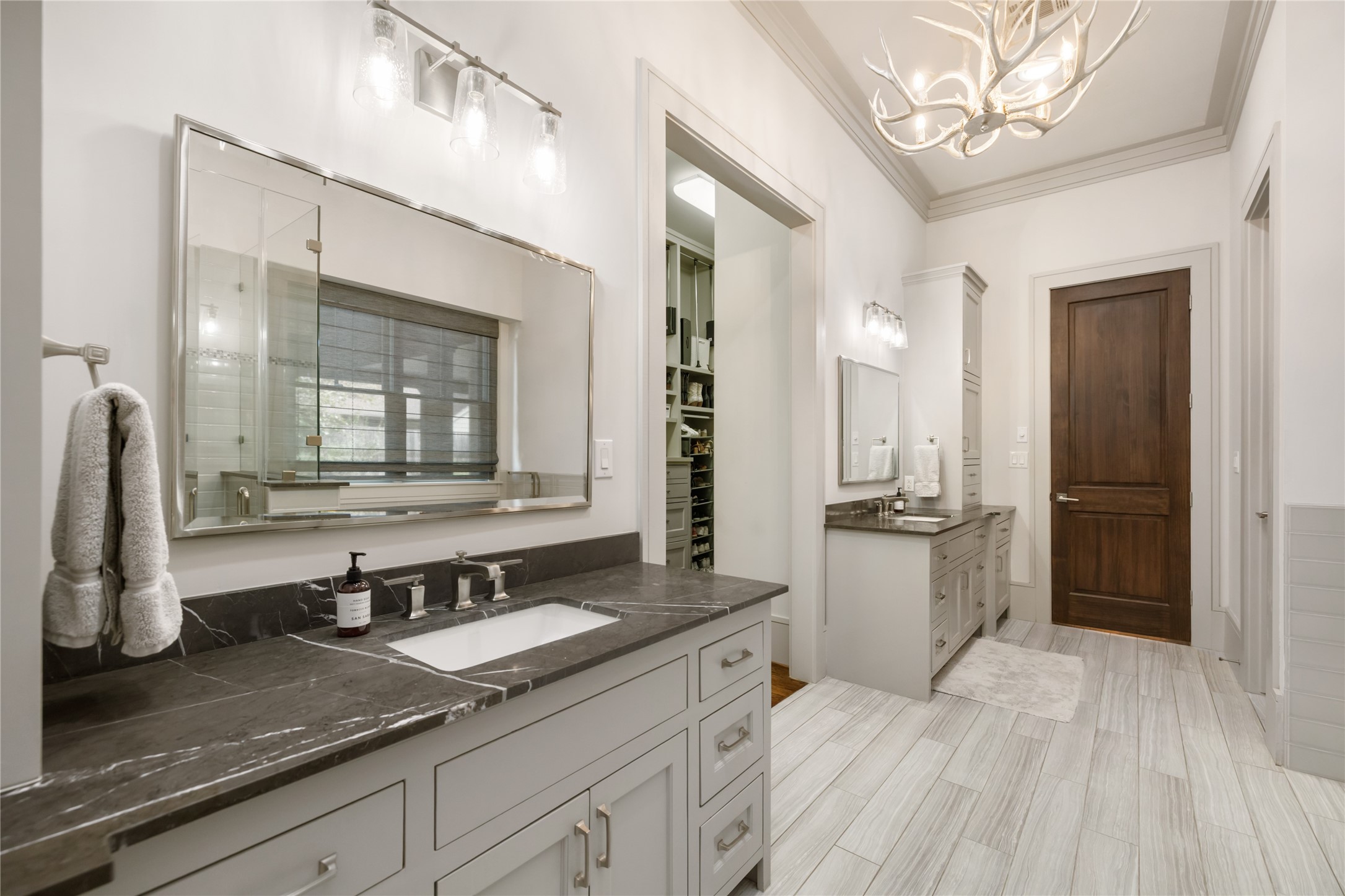 The huge closet is accessible between the double vanities