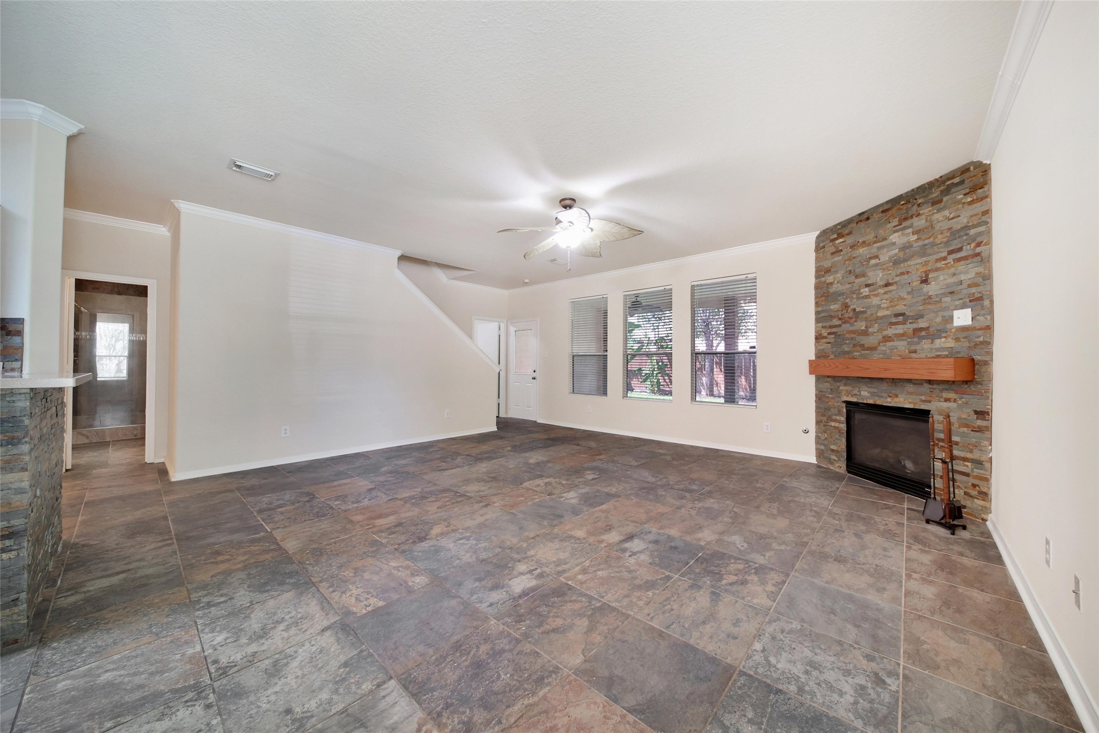 View to the living room with fancy tile and fireplace.