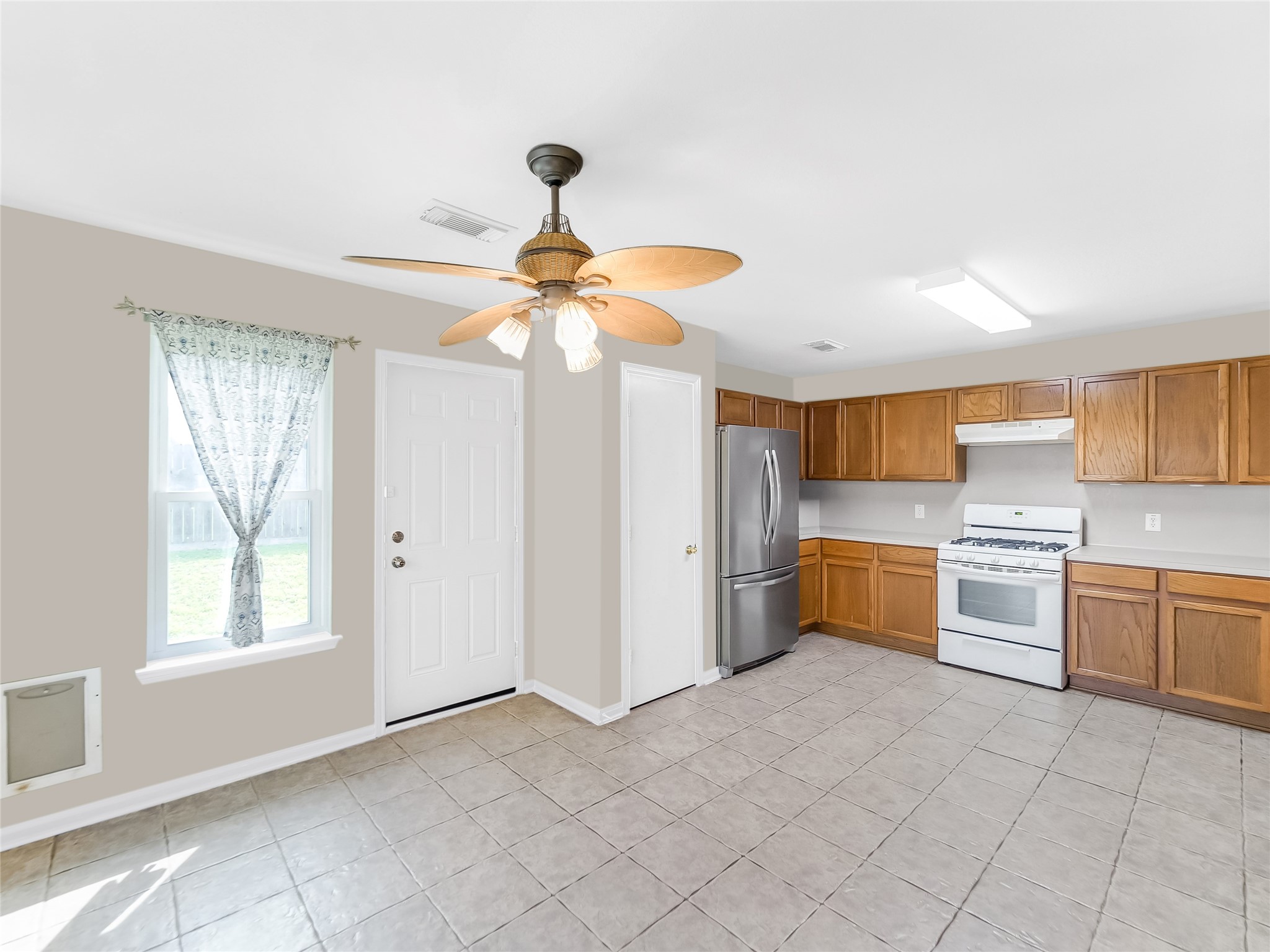 Kitchen with appliances, and natural light.