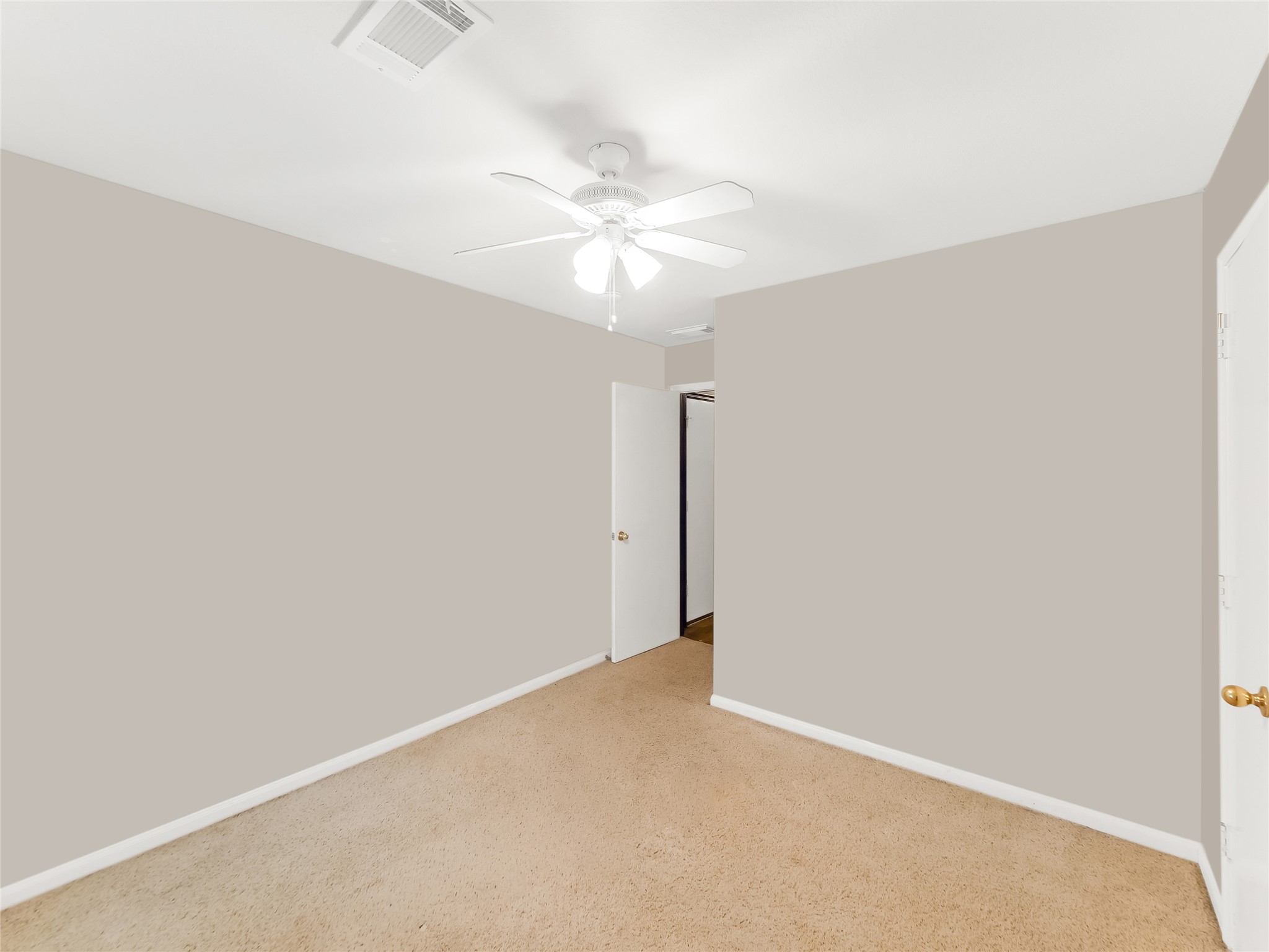 Bedroom with a ceiling fan.