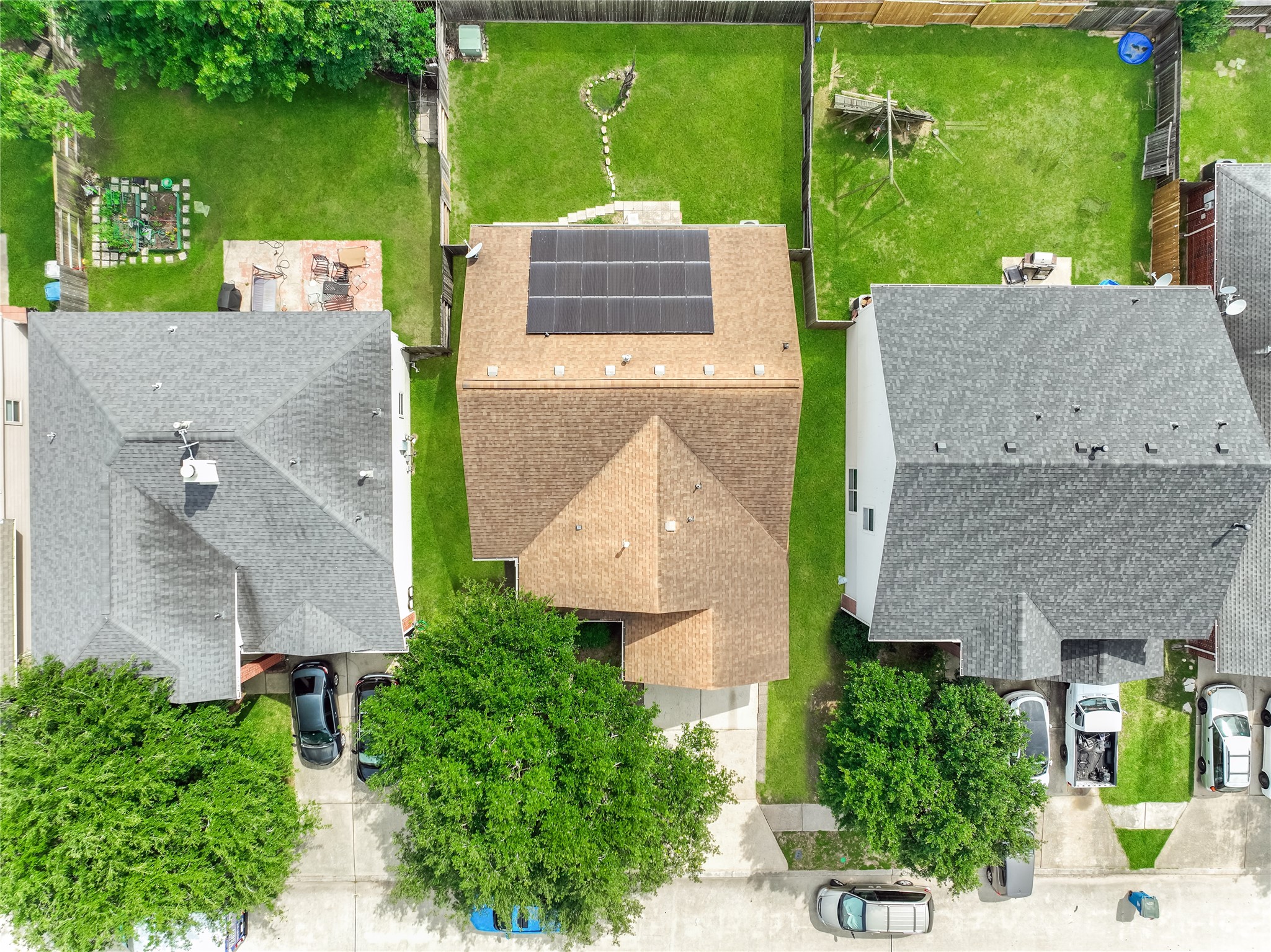 Overhead aerial view of the property with the house, backyard, and neighboring residential lots.