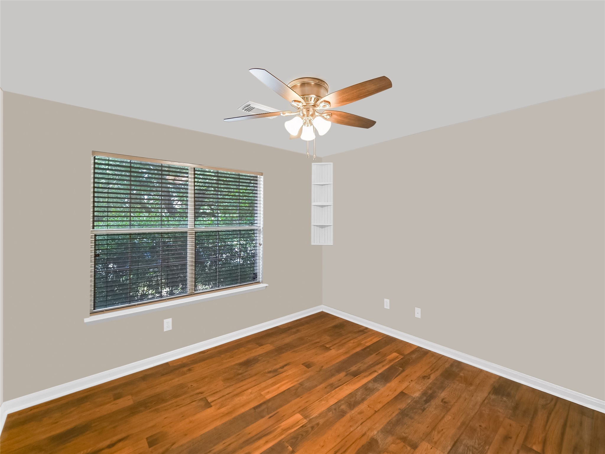 Bedroom with a ceiling fan, and a large window.