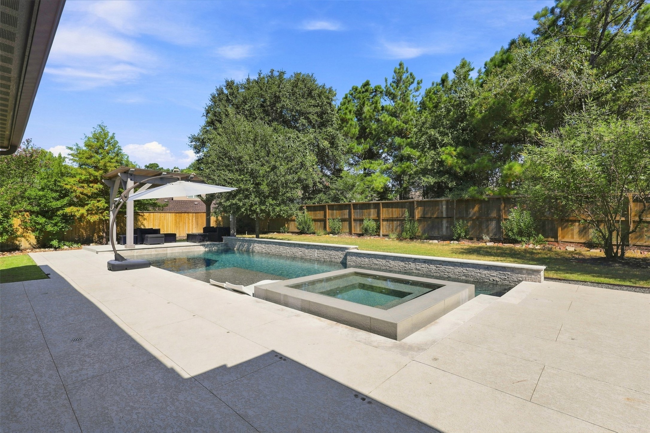 Enjoy the heated pool and attached hot tub year-round, creating the perfect setting for entertaining, relaxing, and making memories.