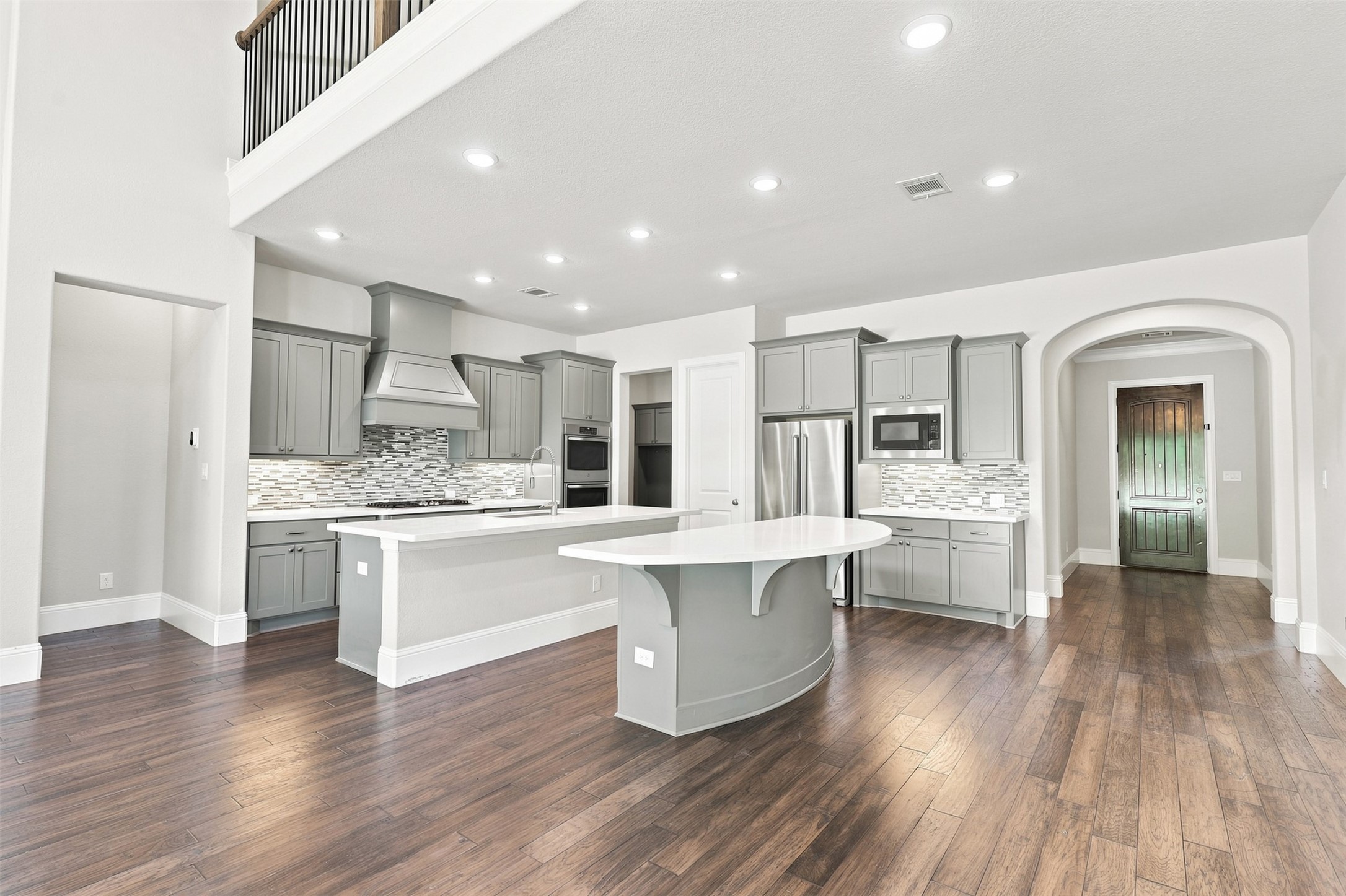 Dual islands providing ample countertop space and seating, perfect for cooking, gathering, and entertaining.
