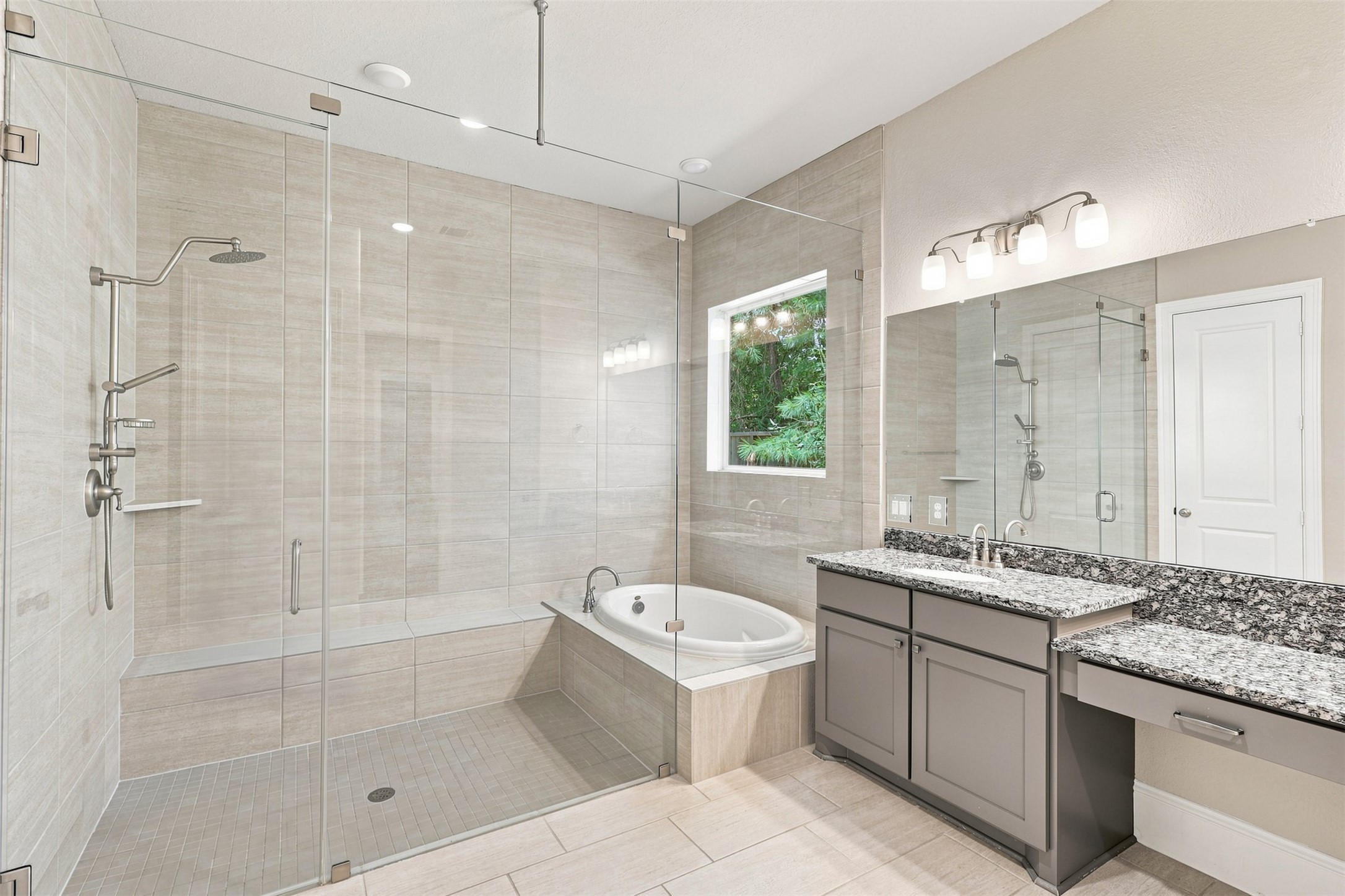 A stunning primary bath showcases a large soaking tub within the walk-in shower, offering a unique design and spa-like feel.