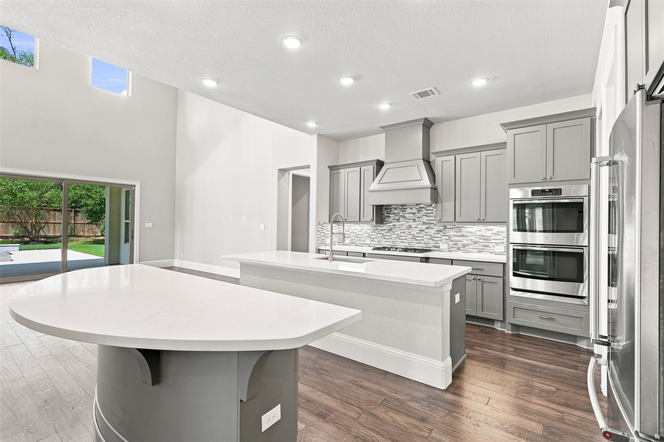 The well-appointed kitchen serves as the heart of the home, opening to the main living and entertaining spaces.