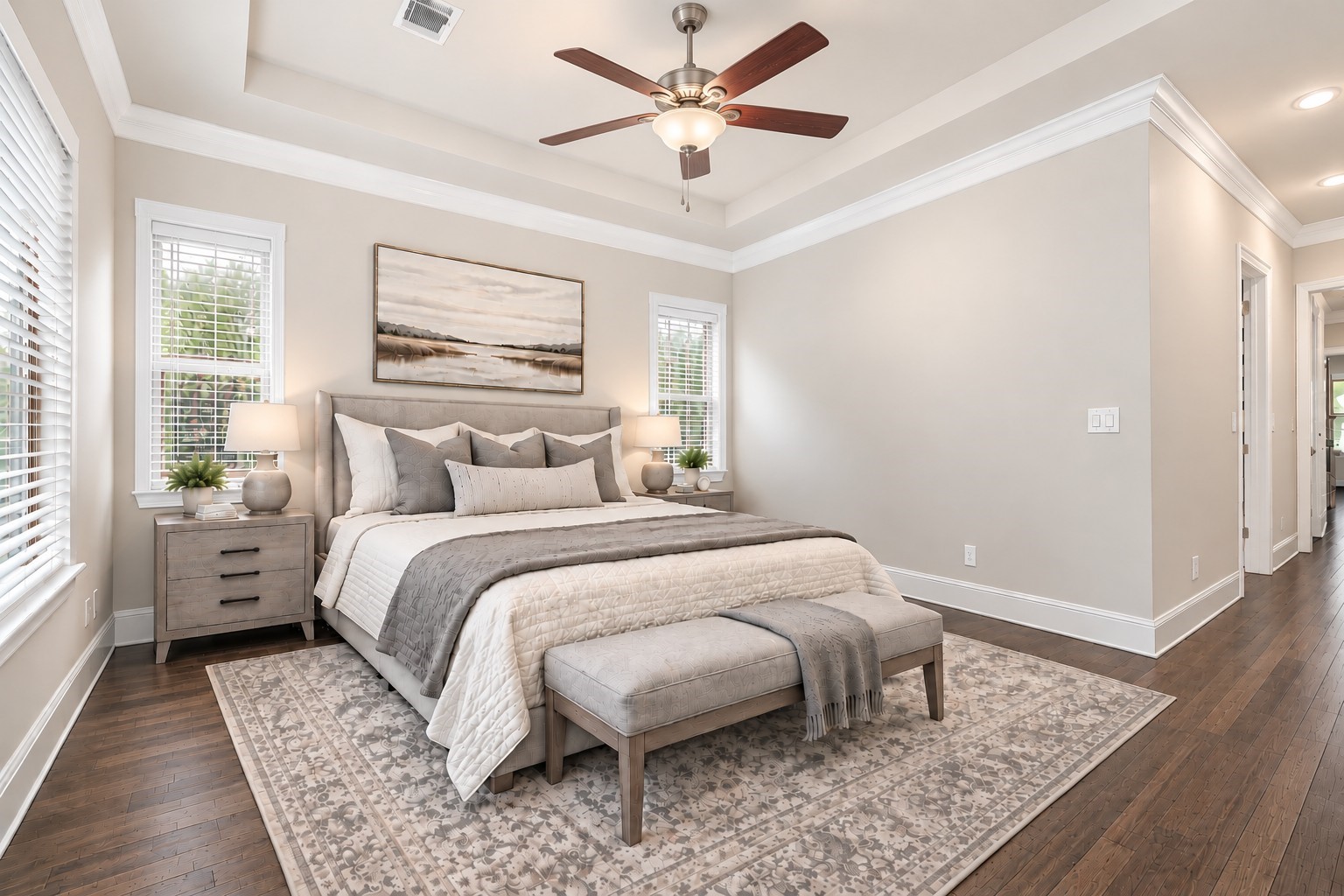 Primary bedroom suite with tray ceiling and upgraded flooring. VIRTUALLY STAGED