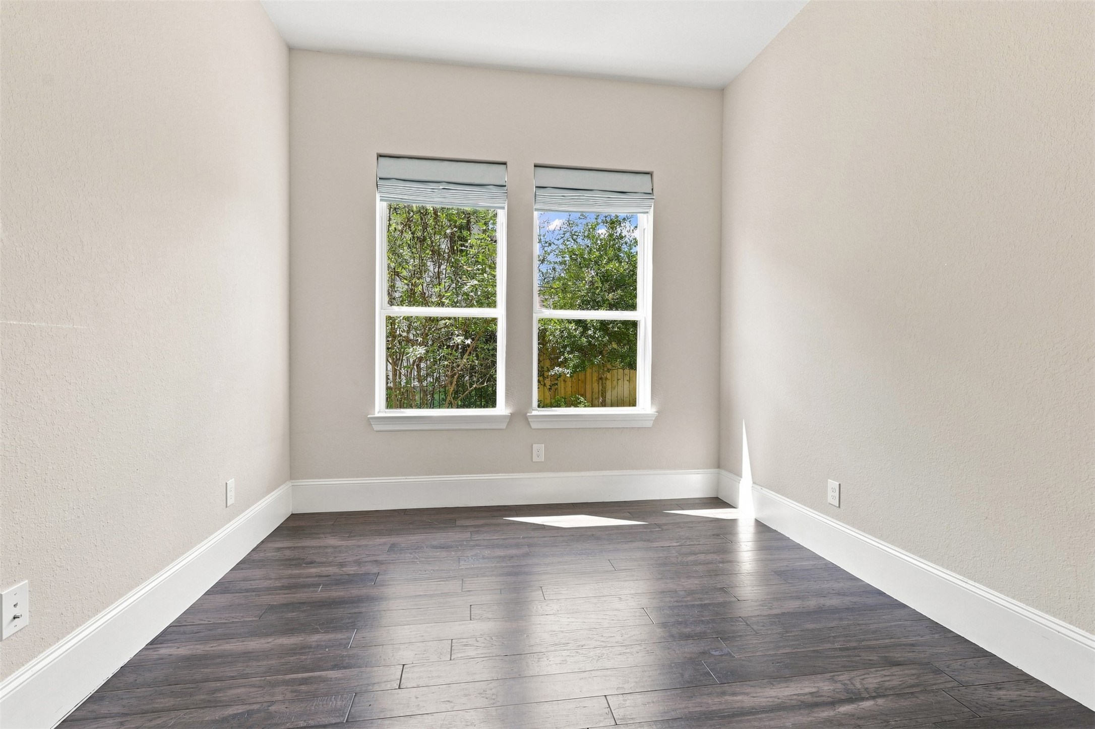 The private study provides a comfortable and a functional home office, library, or flex space with plenty of natural light.