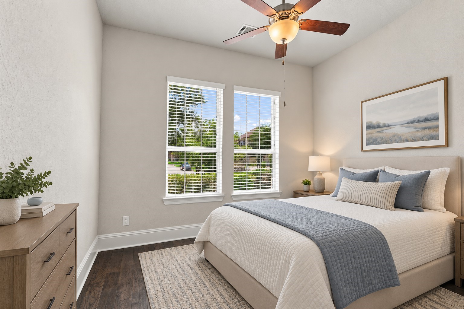 The secondary main-level bedroom features a private en-suite bath, creating a comfortable and private retreat for family or guests. VIRTUALLY STAGED