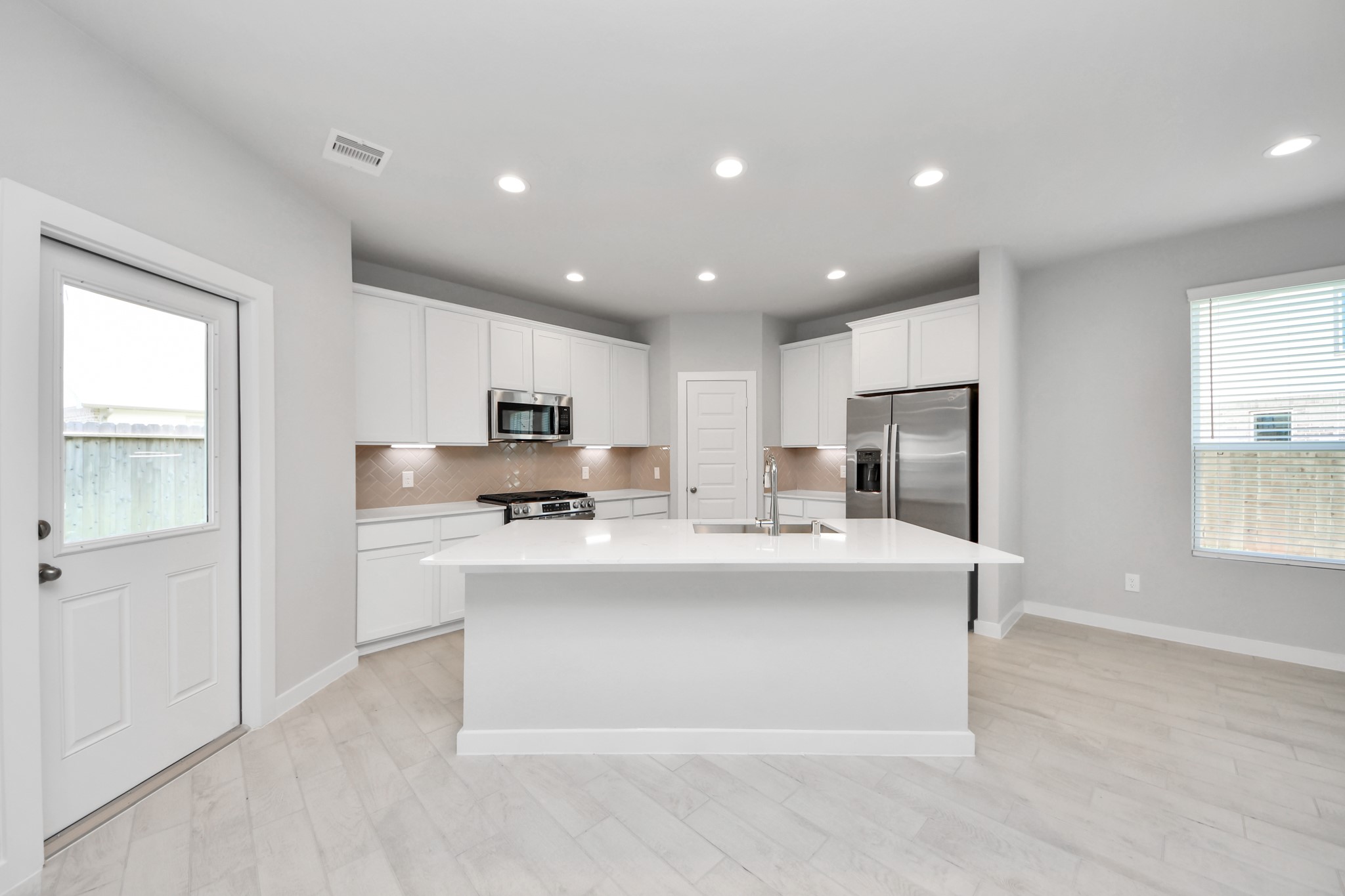 The extended counter area adds both practicality and style, making meal preparation a breeze. Every detail is thoughtfully designed to enhance the kitchen's functionality and aesthetic appeal. Sample photo of completed home with similar floor plan. Actual colors and selections may vary.