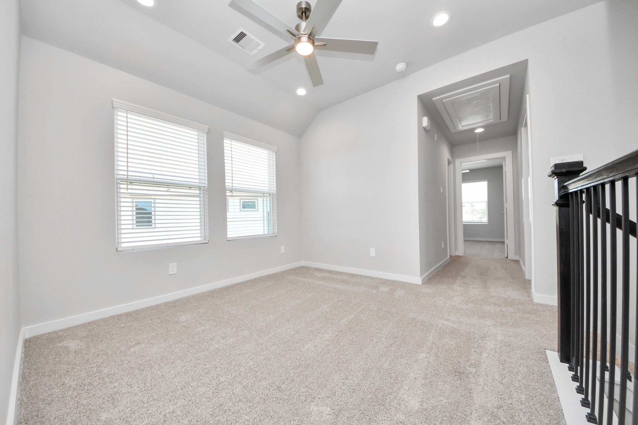 Discover a haven of leisure in this fantastic game room! Whether you're seeking a casual hangout or an adult gaming retreat, this space has it all. Enjoy the luxurious feel of plush carpet underfoot, the expansive ambiance of high ceilings, custom paint that adds a touch of personality, and windows that flood the room with refreshing natural light. Sample photo of completed home with similar floor plan. Actual colors and selections may vary.