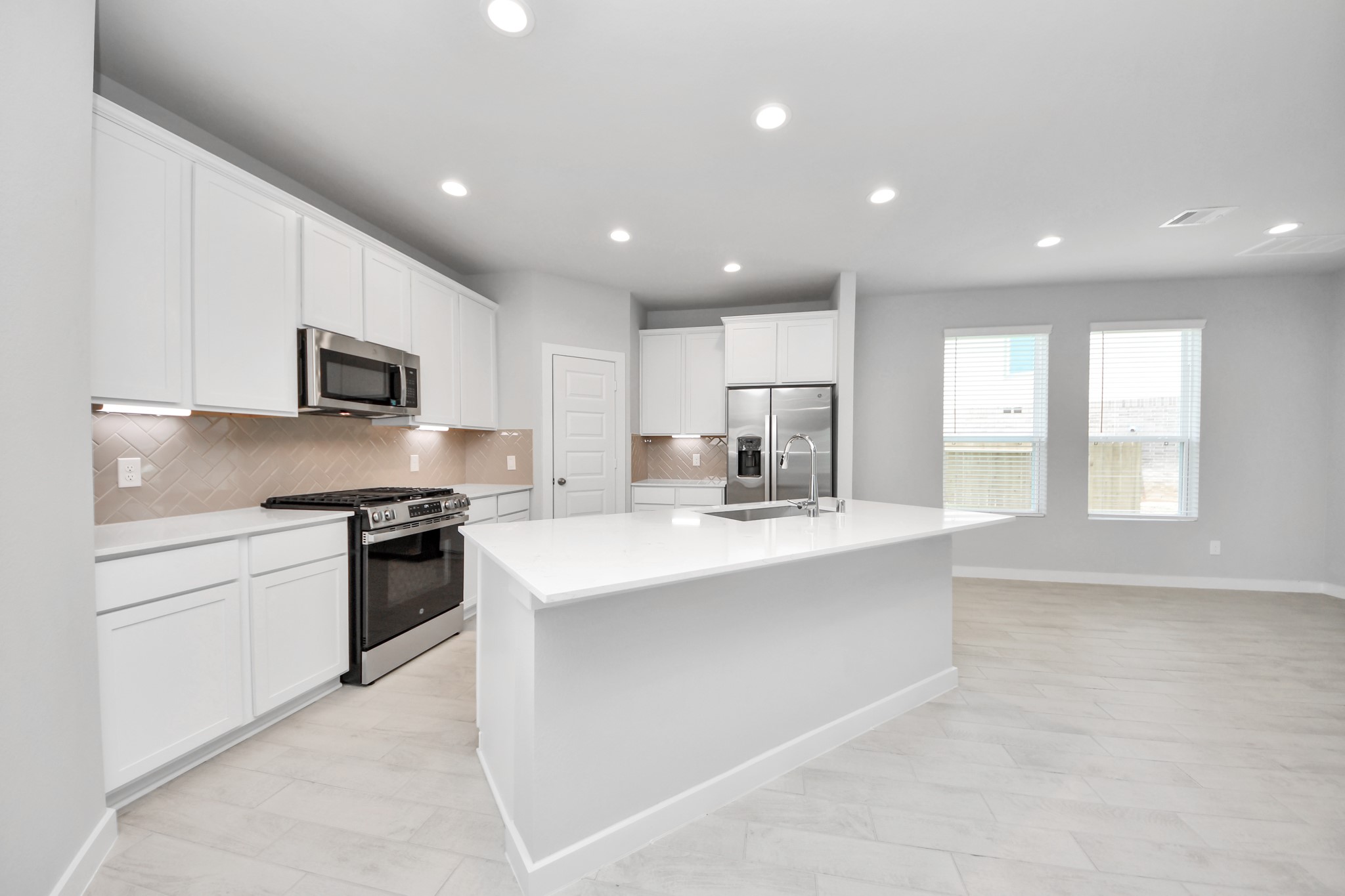 The open concept effortlessly connects the kitchen to the expansive family room, forming a perfect hub for gatherings. This seamless flow creates an inviting space where cooking and socializing come together harmoniously. Sample photo of completed home with similar floor plan. Actual colors and selections may vary.
