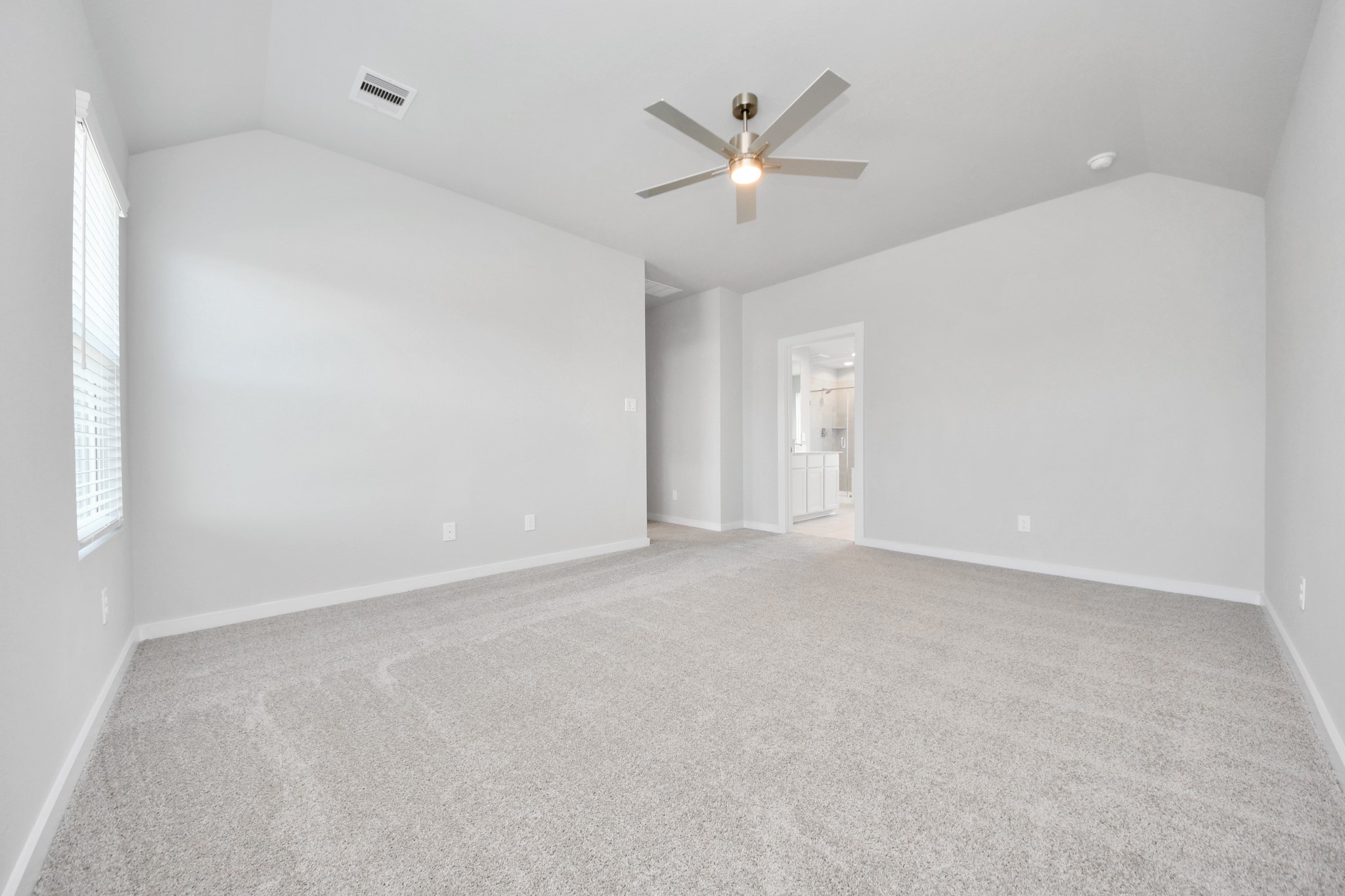 Come and unwind after a long day in this magnificent primary suite! This spacious room features plush carpet, warm paint, high ceilings and large windows with privacy blinds. Sample photo of completed home with similar floor plan. Actual colors and selections may vary.