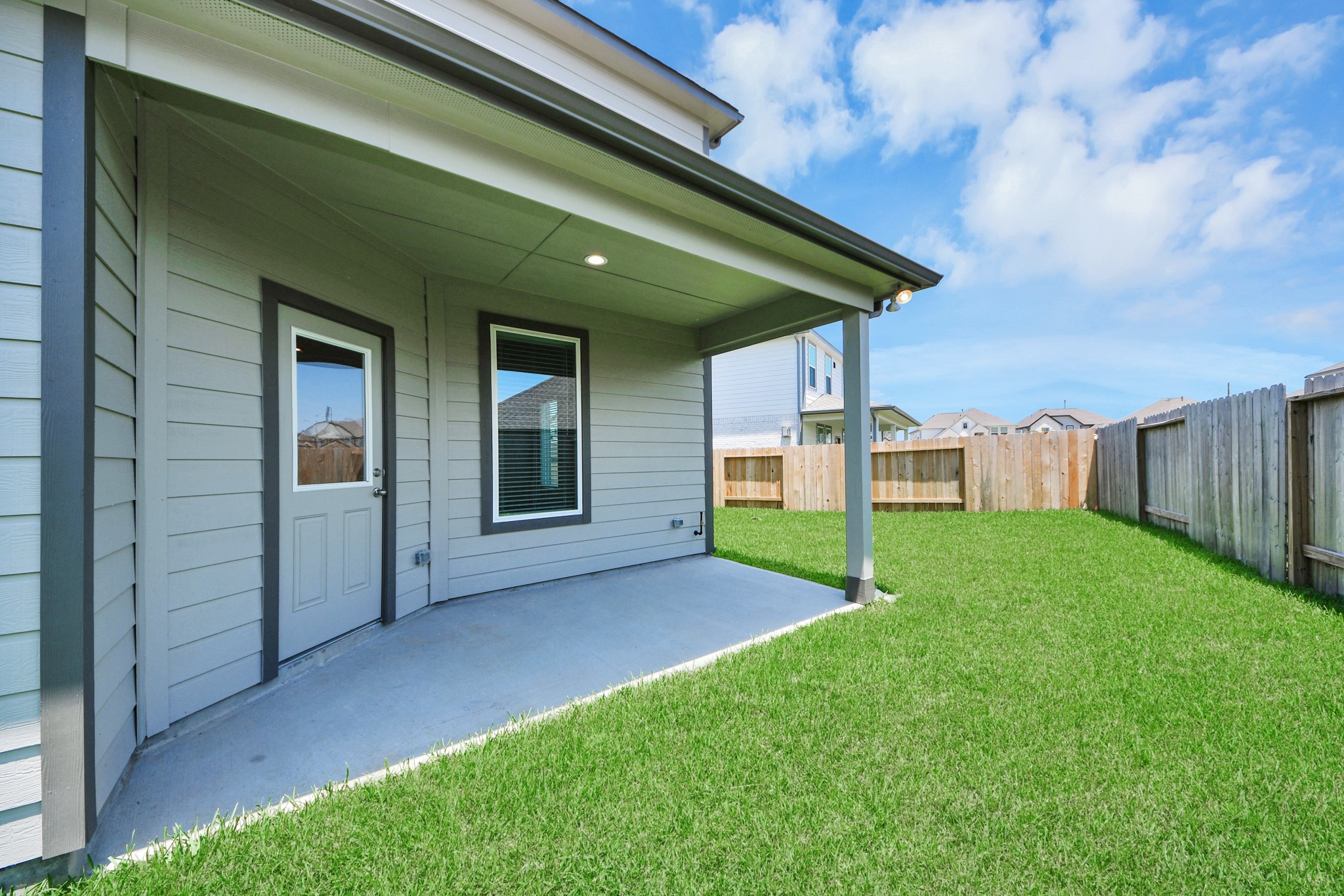 Come and see this spacious backyard with its beautiful covered patio. There is plenty of room for the kids to play and adults to relax. Perfect for your outdoor living space, patio furniture, bbq pit, and so much more. The possibilities are endless! Sample photo of completed home with similar floor plan. Actual colors and selections may vary.