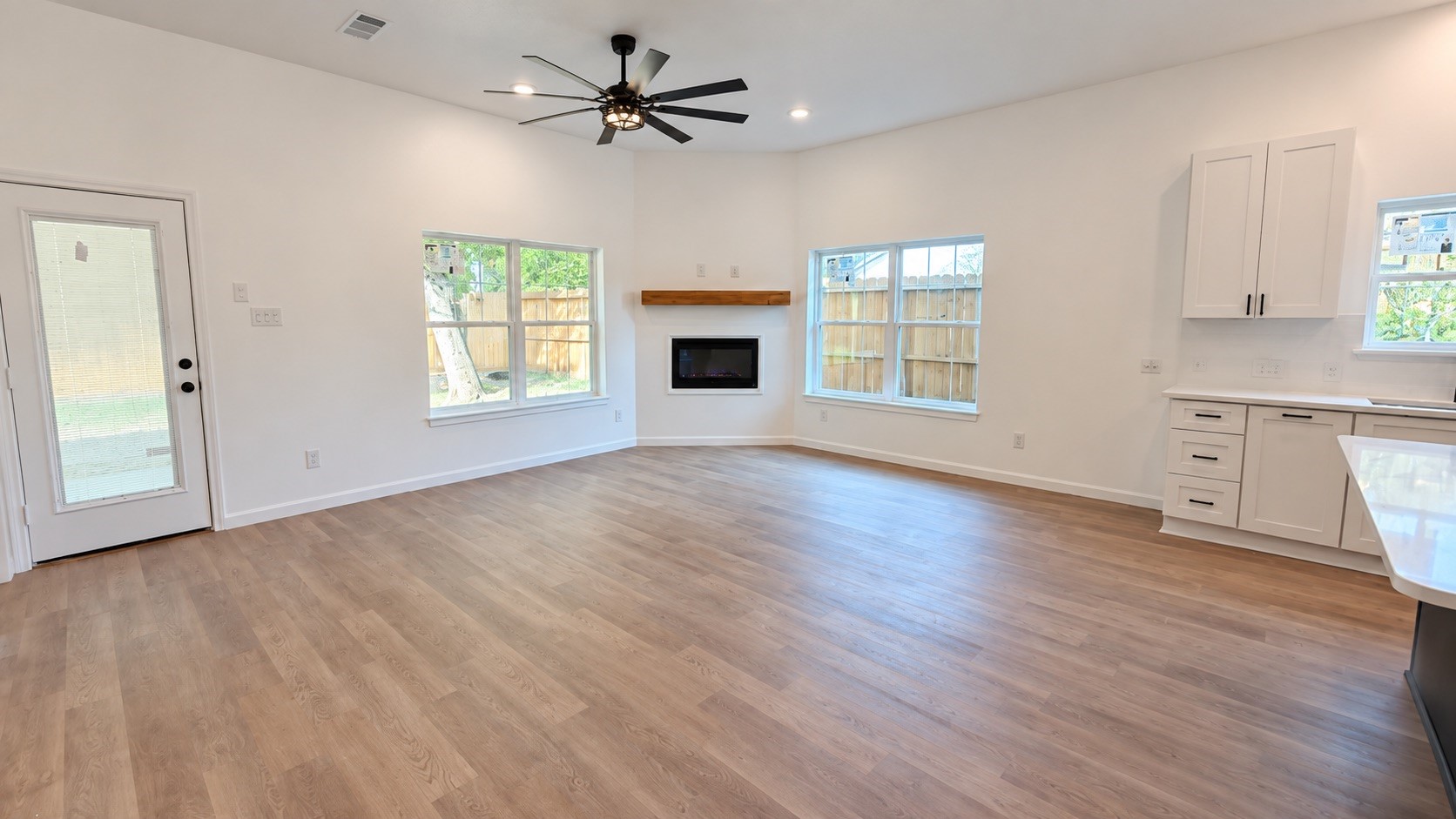 Modern electric fireplace featuring a stylish wood accent wall for a warm and contemporary look.