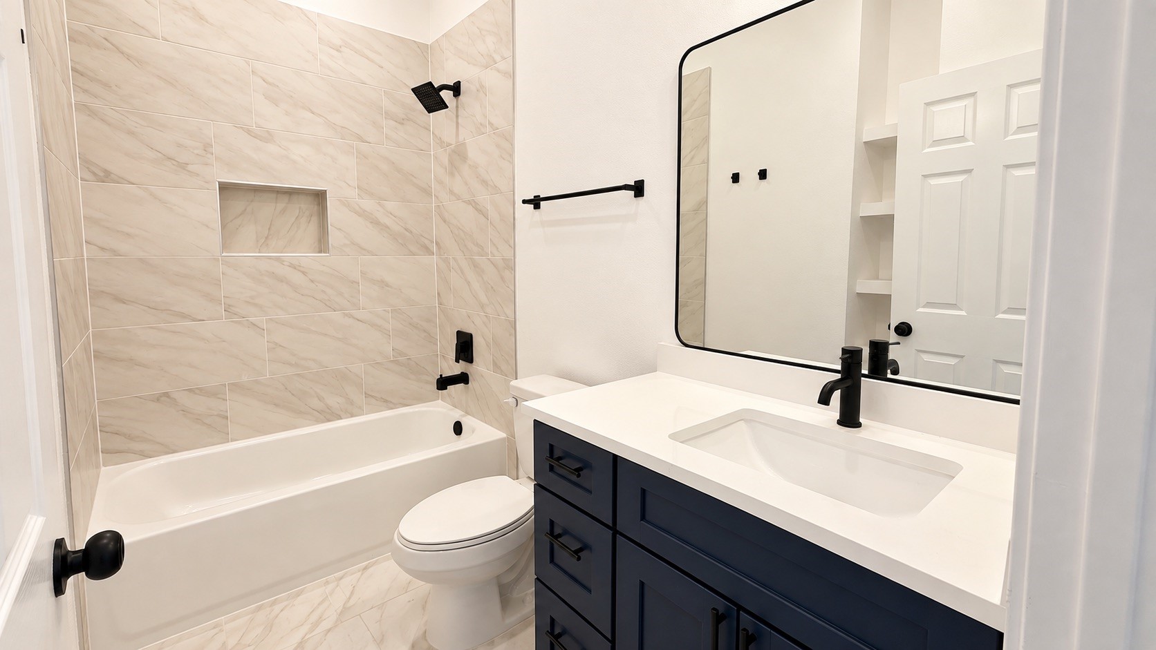 Modern guest bathroom featuring a beautiful color palette and elegant lighting fixtures.