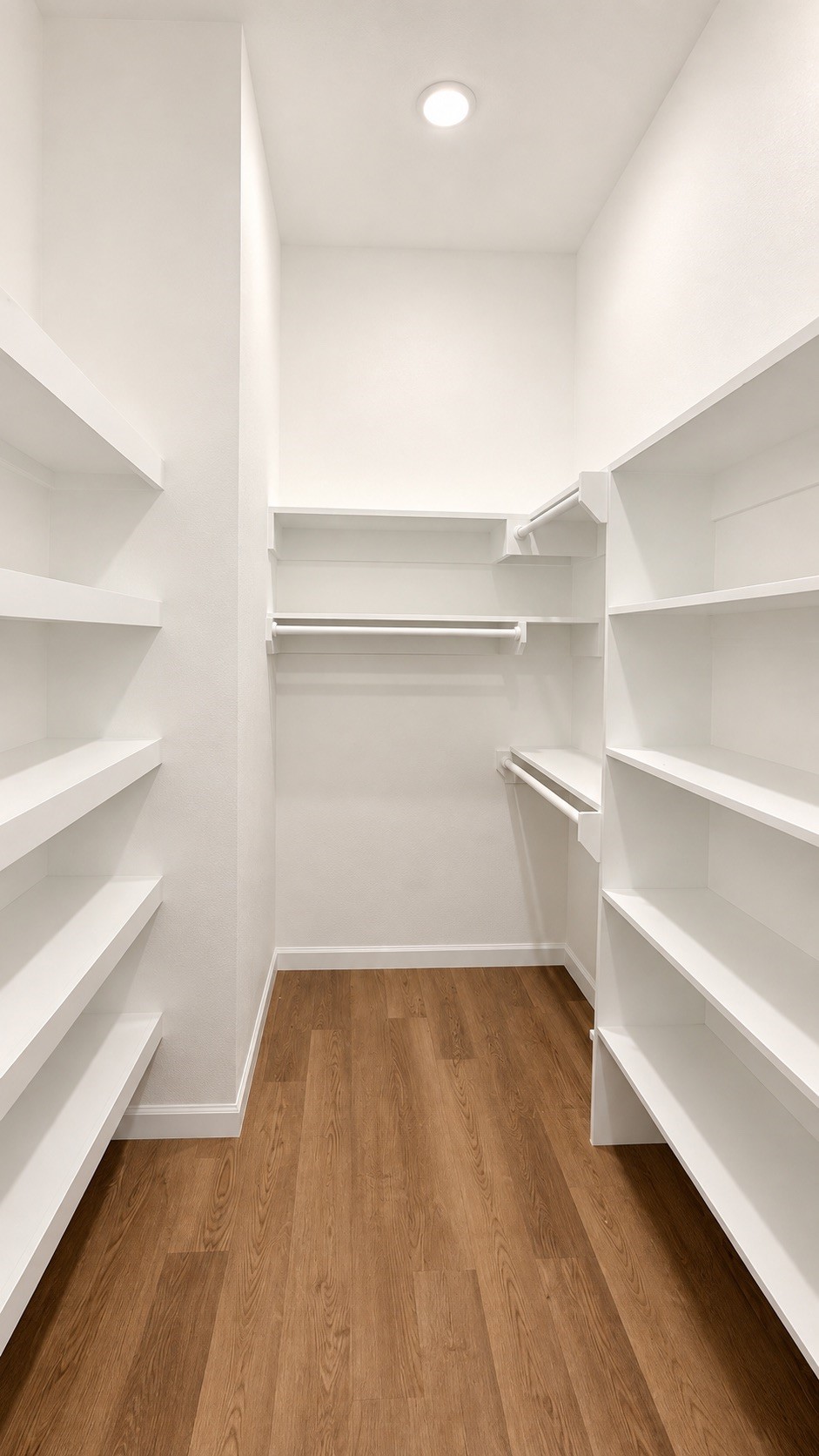 Custom-designed walk-in closet offering stylish organization and helping you save on additional storage costs.