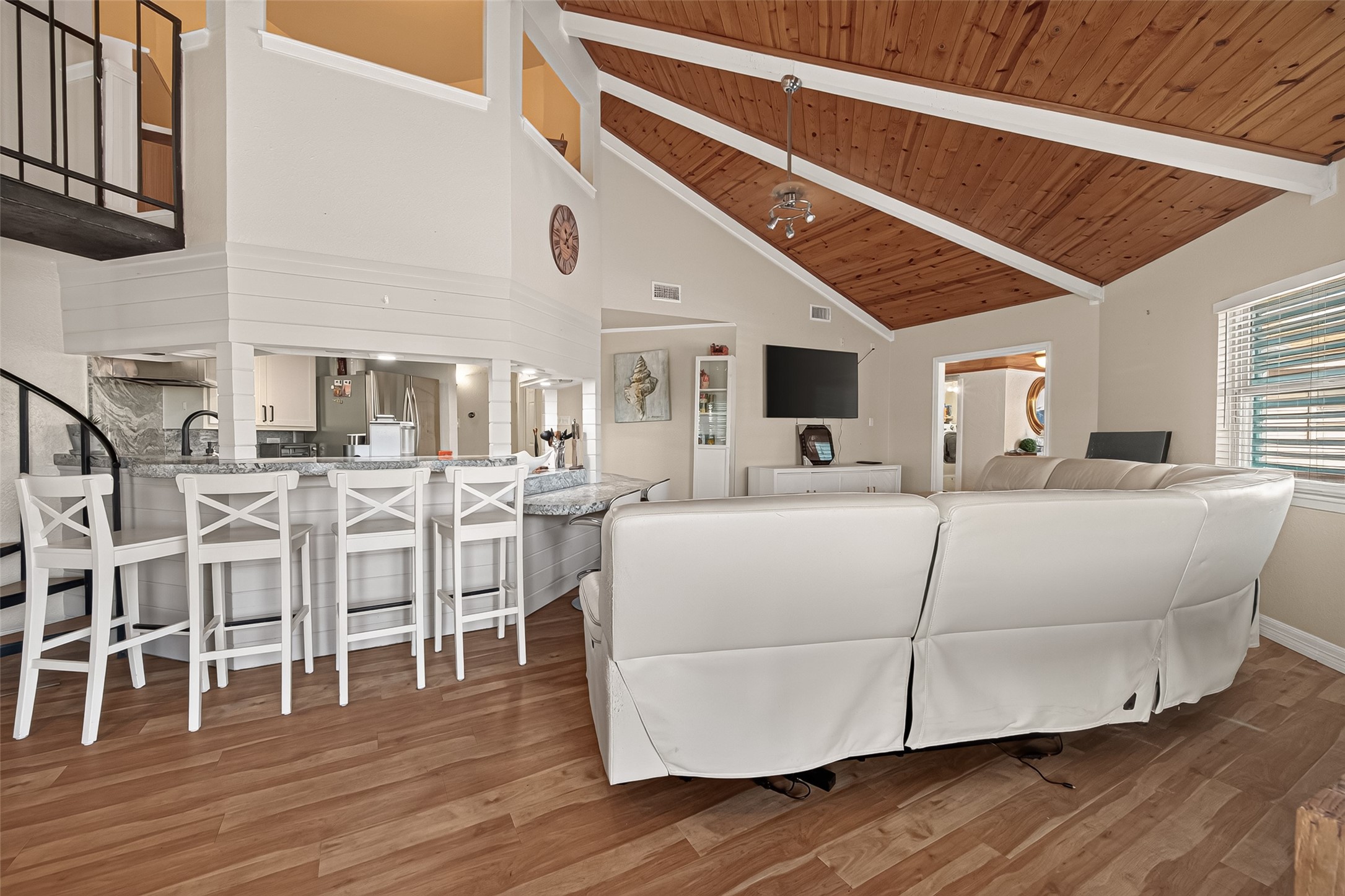 Sloping roof lines and angled ceiling planes lead the eye upward to the unique bird's-nest office hovering directly over the kitchen hub. Sloping roof lines and angled ceiling planes lead the eye upward to the unique bird's-nest office hovering directly over the kitchen hub.
