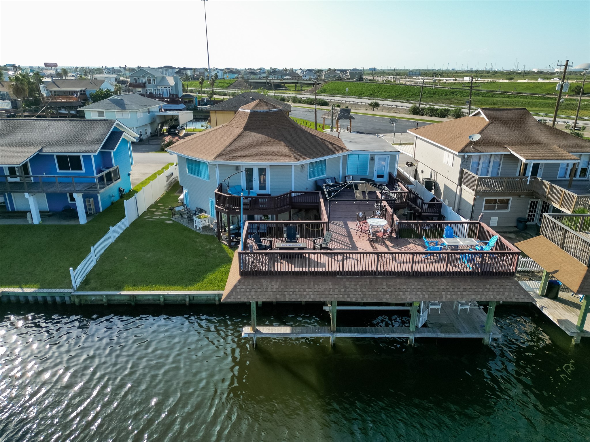 A bird's-eye showcase of elite waterfront livinghighlighting the massive upper deck, boathouse, and direct access to the canal network.