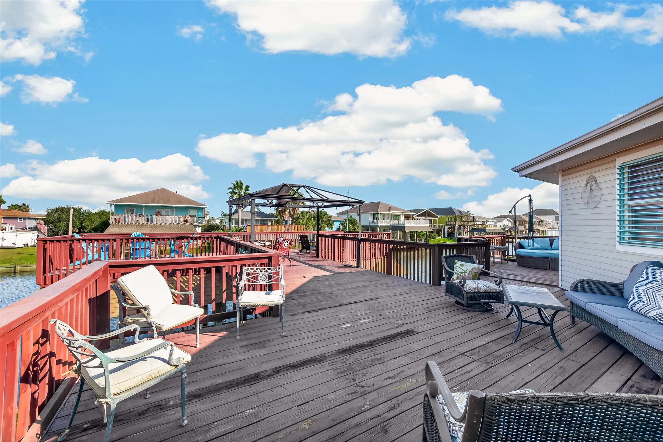 The crown jewel of the exterioran extraordinary, elevated deck with a removable gazebo and branching into multiple lounge zones with endless water views.