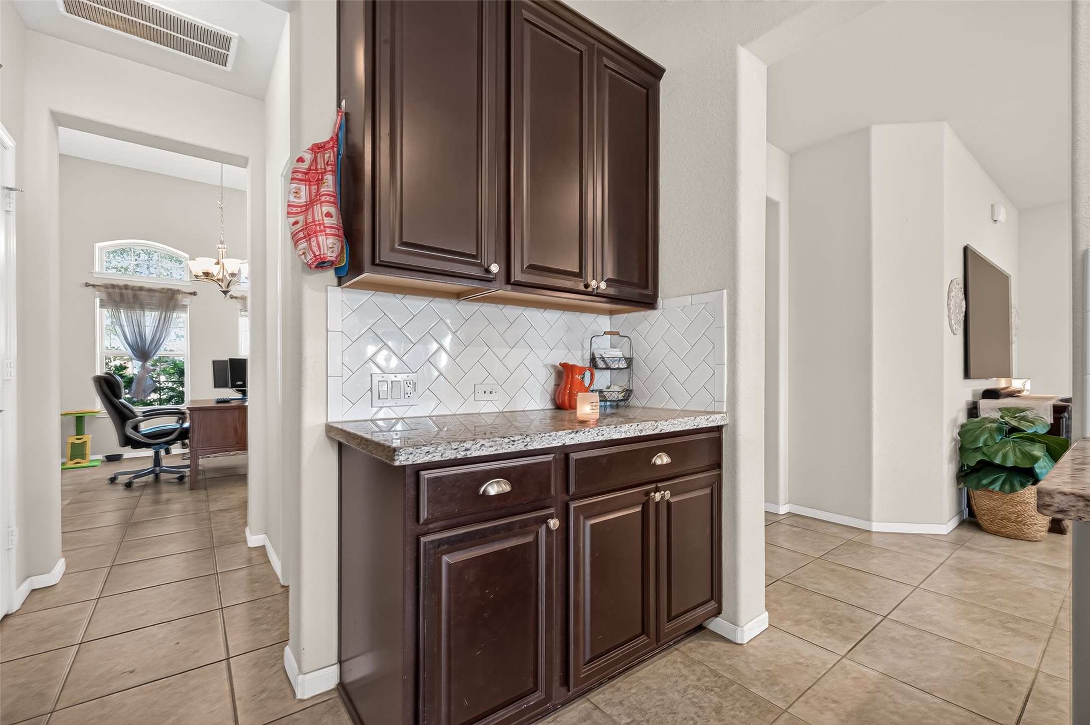 Additional counter space and cabinetry provide a convenient spot for coffee or serving.