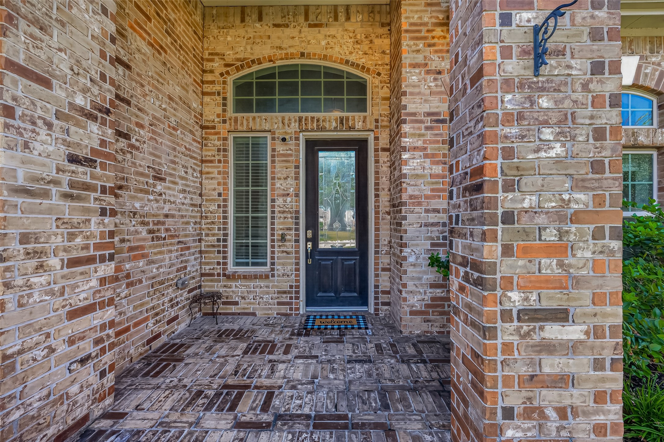 A sheltered brick porch creates a welcoming entrance for you and your guests.