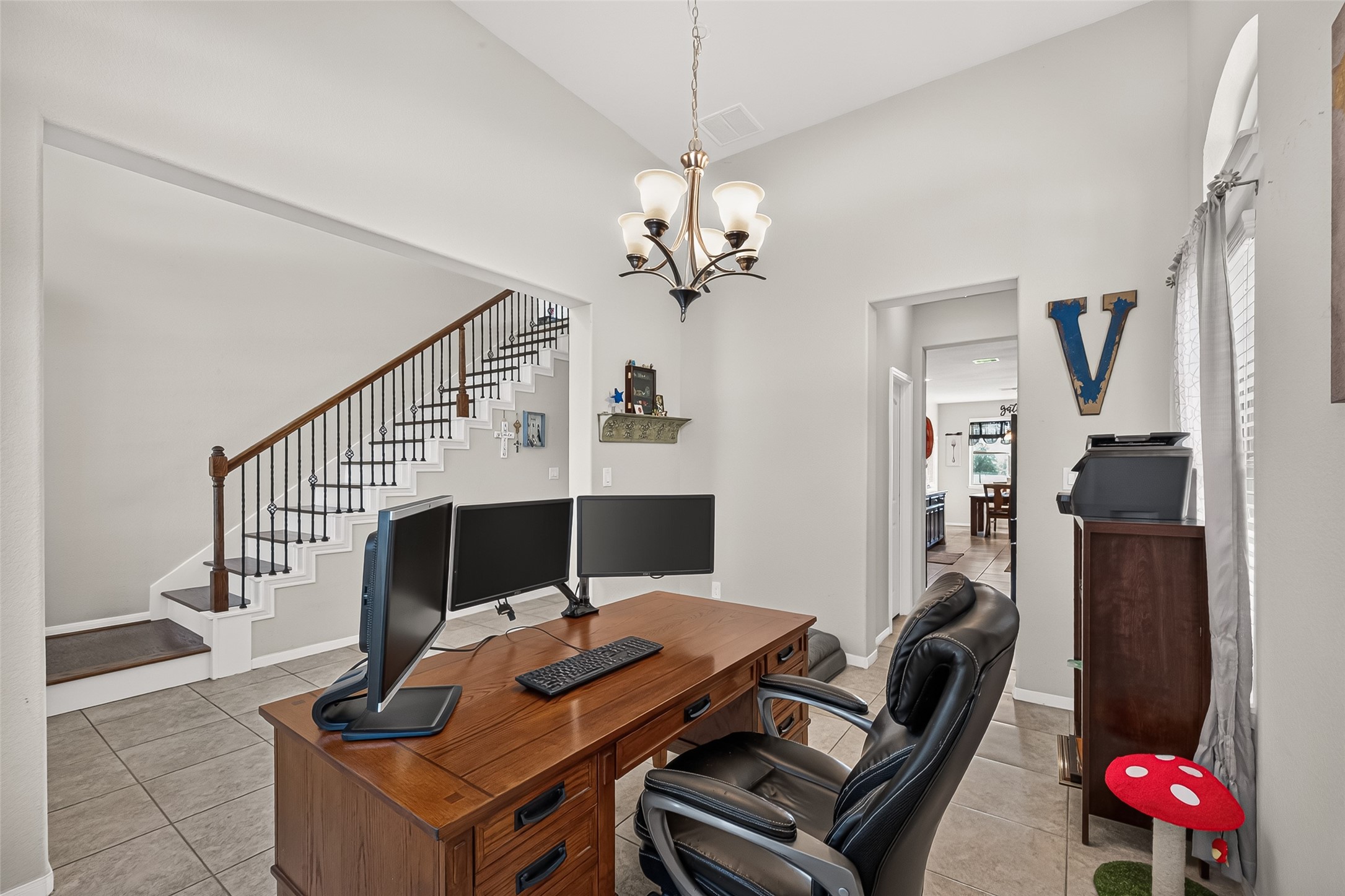 A versatile front room offers space for a home office or formal dining area.