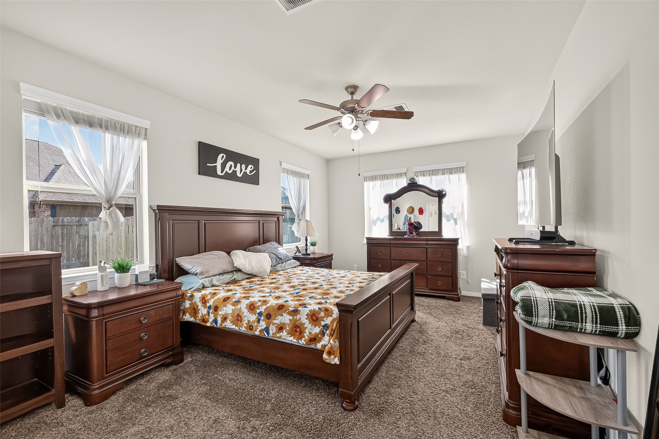 The downstairs primary bedroom offers a spacious layout and plenty of natural light.