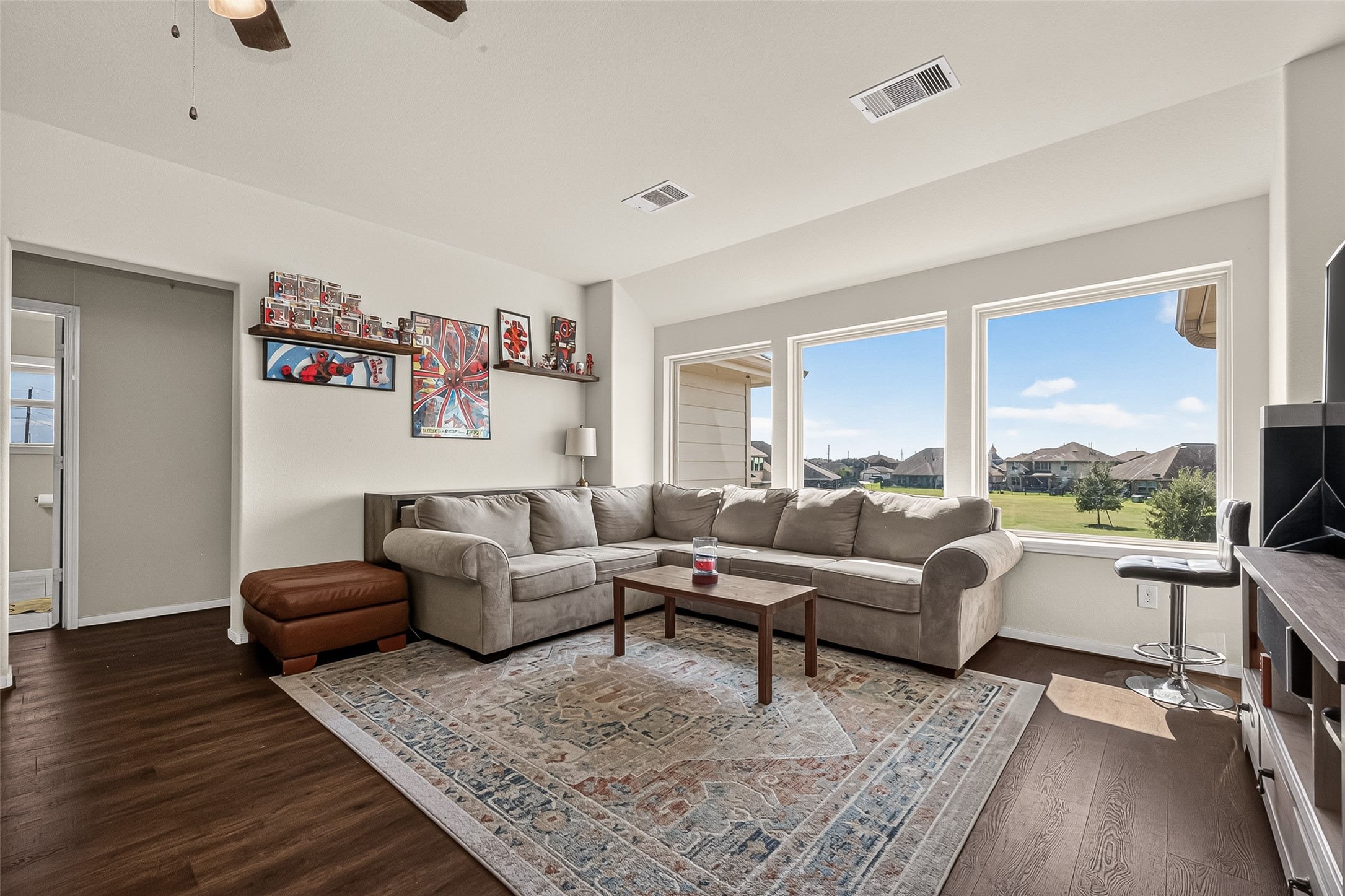 Large windows frame park views from this Kingdom Heights home's upstairs game room.