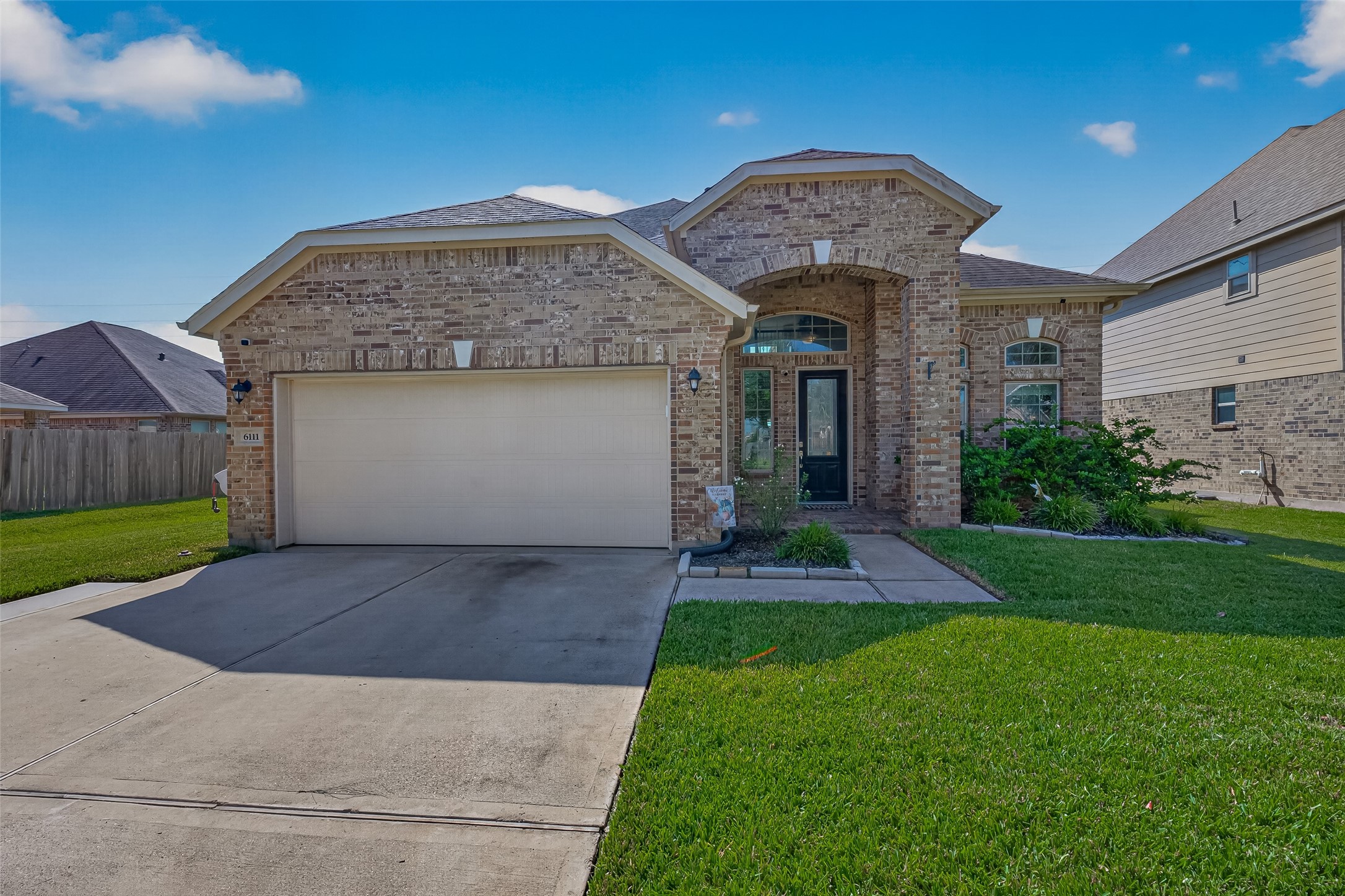 Welcome to 6111 Wayne Way in Kingdom Heights, Rosenberg, TX, featuring a brick exterior and inviting covered entry.
