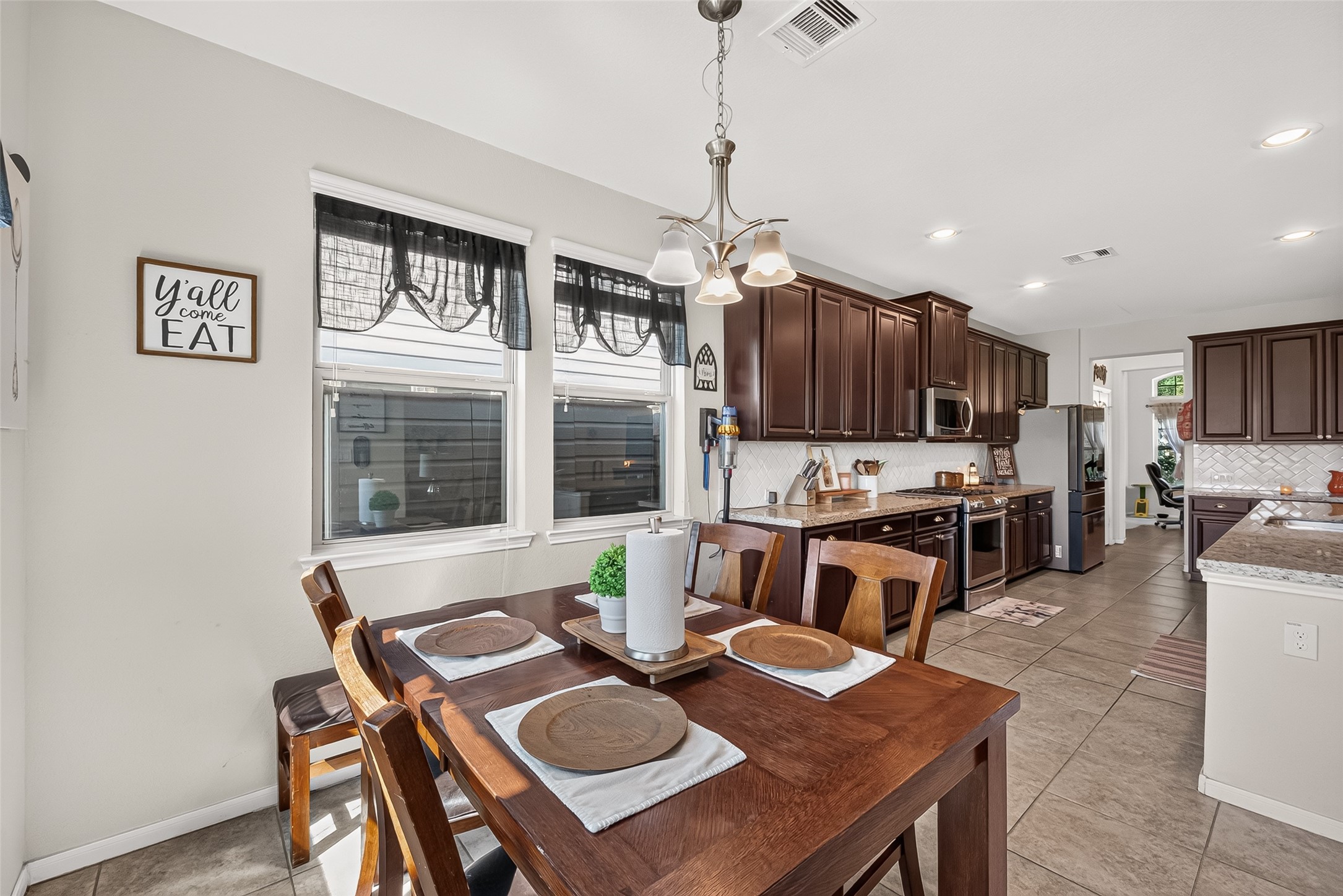 The breakfast area sits conveniently between the kitchen and covered back patio.