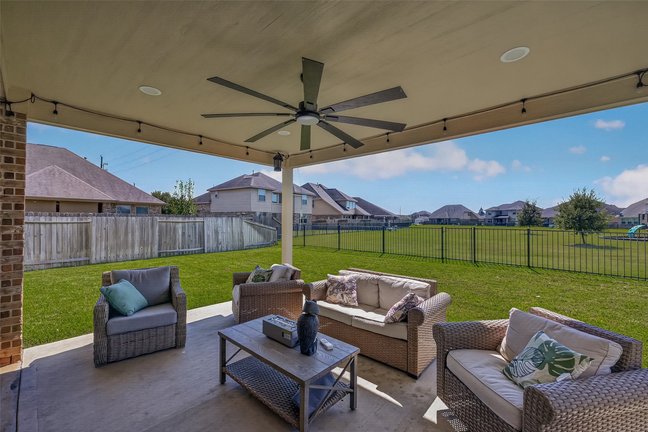 The covered outdoor seating area offers a comfortable setting for conversation or a quiet evening.