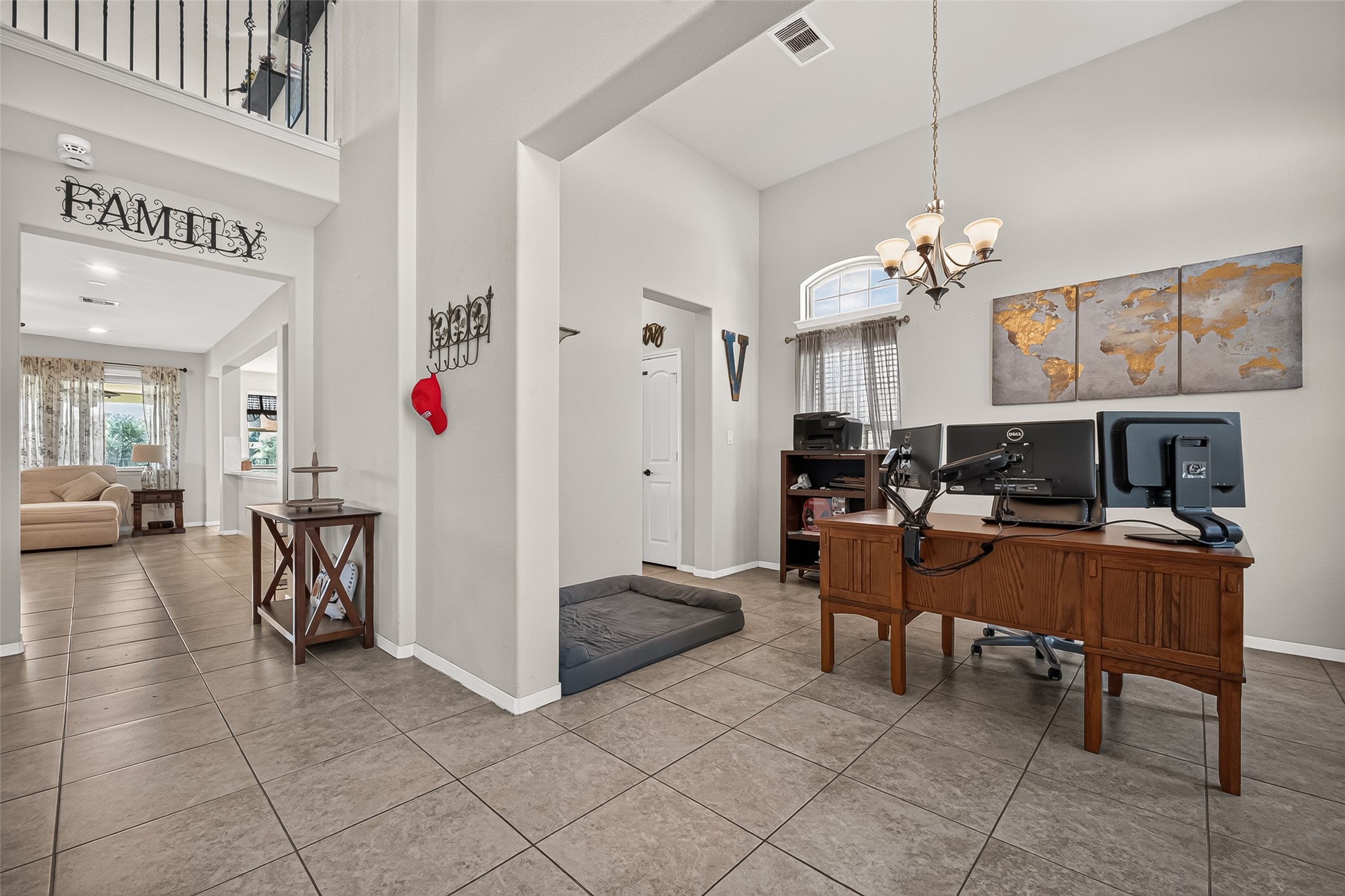 The open foyer connects the flexible front room with the main living spaces.