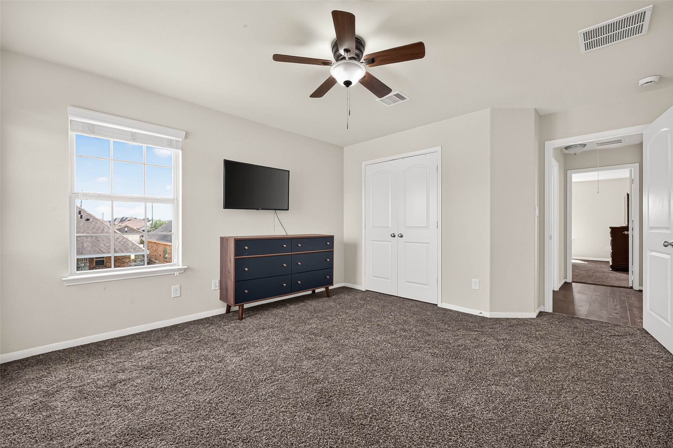 This additional upstairs bedroom offers flexible space and a bright window.