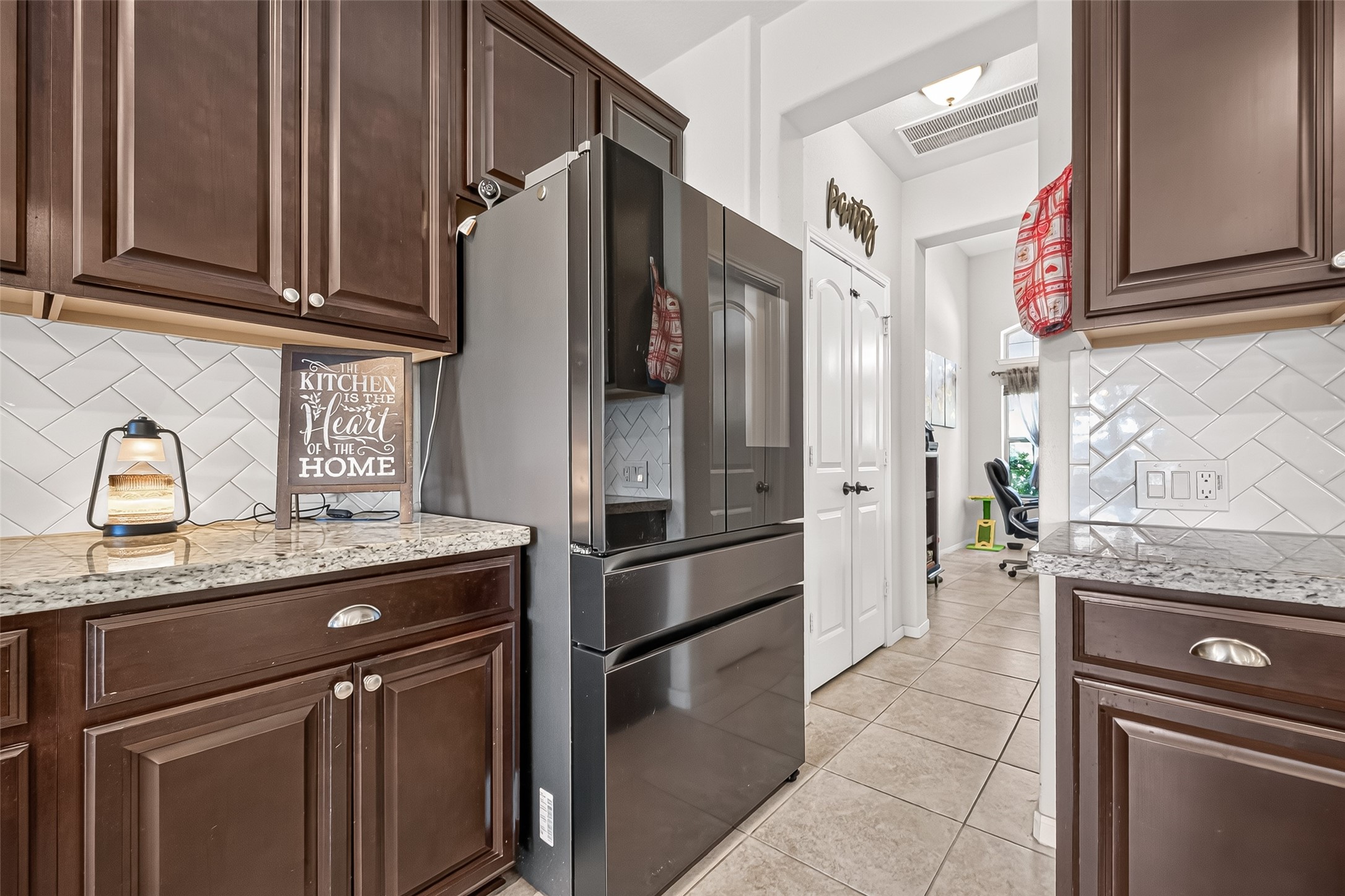 The kitchen offers coordinated appliances and easy access to adjacent living areas.