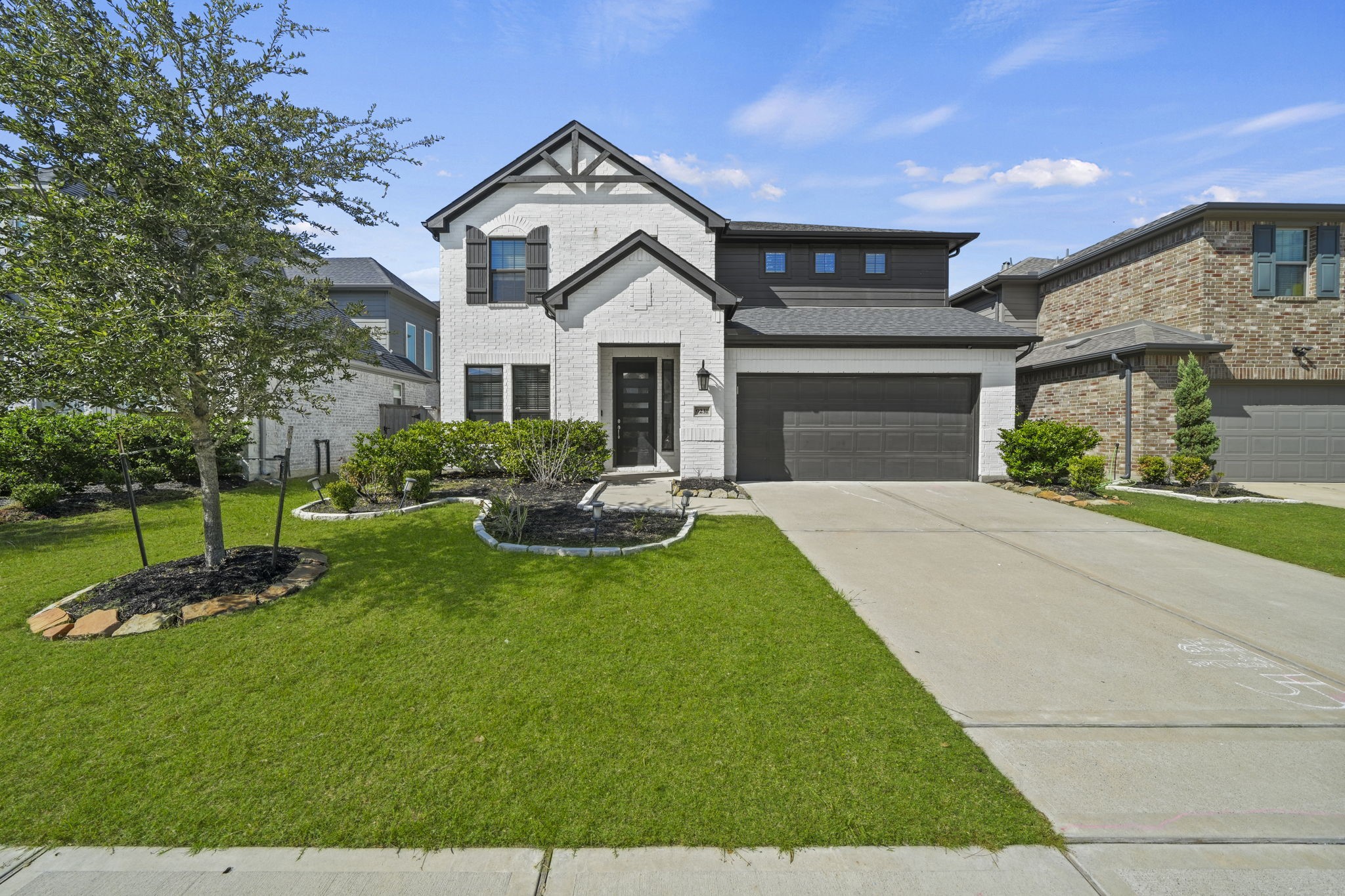 Welcome home to 9231 Dearborn Knoll Drive! White brick, dark accents, and a modern front door make a great first impression. Welcome home to 9231 Dearborn Knoll Drive! White brick, dark accents, and a modern front door make a great first impression.