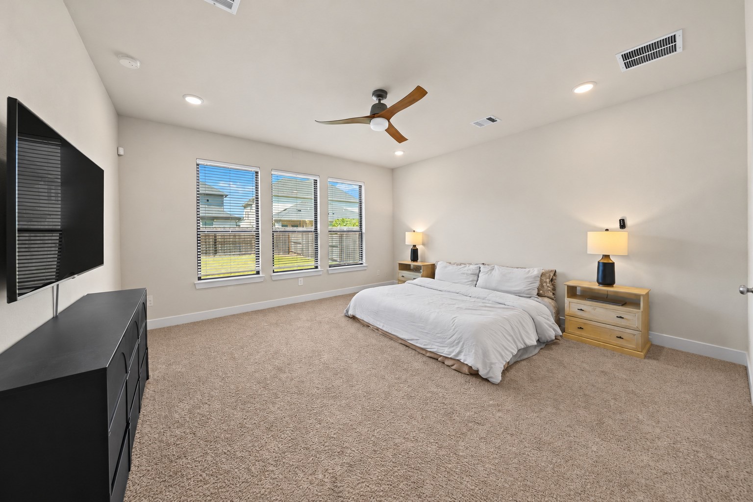 Your first-floor primary suite offers generous space, three large windows, and plush carpet, a comfortable retreat at the end of the day. Your first-floor primary suite offers generous space, three large windows, and plush carpet, a comfortable retreat at the end of the day.