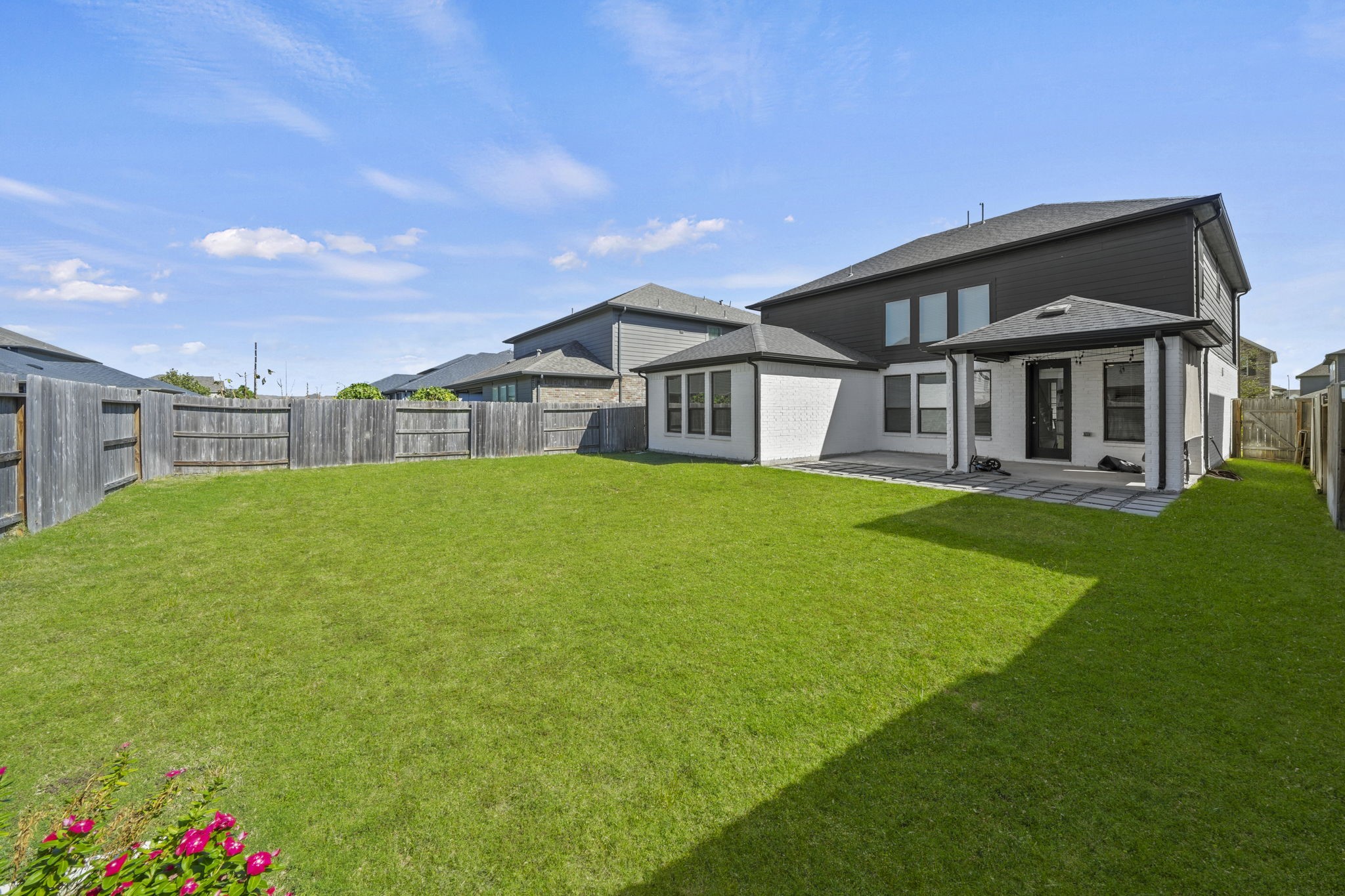 Step outside to an expansive, fully fenced backyard with a covered patio, perfect for relaxing, playing, or hosting a weekend cookout.