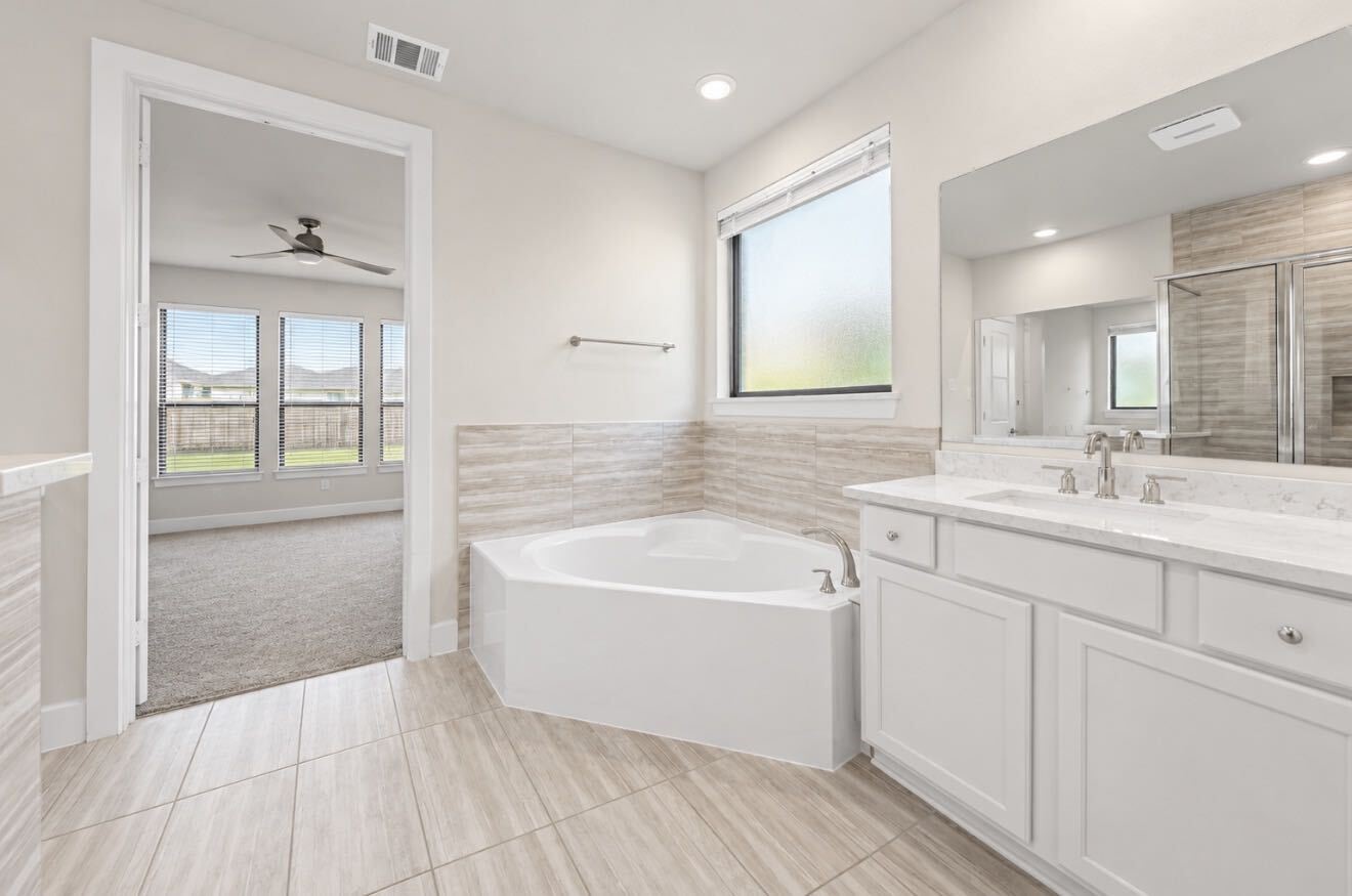 Another view of the primary bath highlighting the relaxing soaking tub. Another view of the primary bath highlighting the relaxing soaking tub.