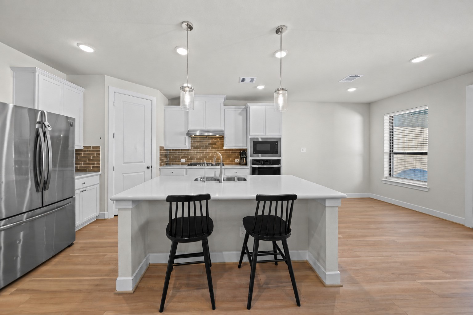 The island with seating anchors this kitchen, and a breakfast nook right beside it makes casual meals and morning coffee easy. The island with seating anchors this kitchen, and a breakfast nook right beside it makes casual meals and morning coffee easy.